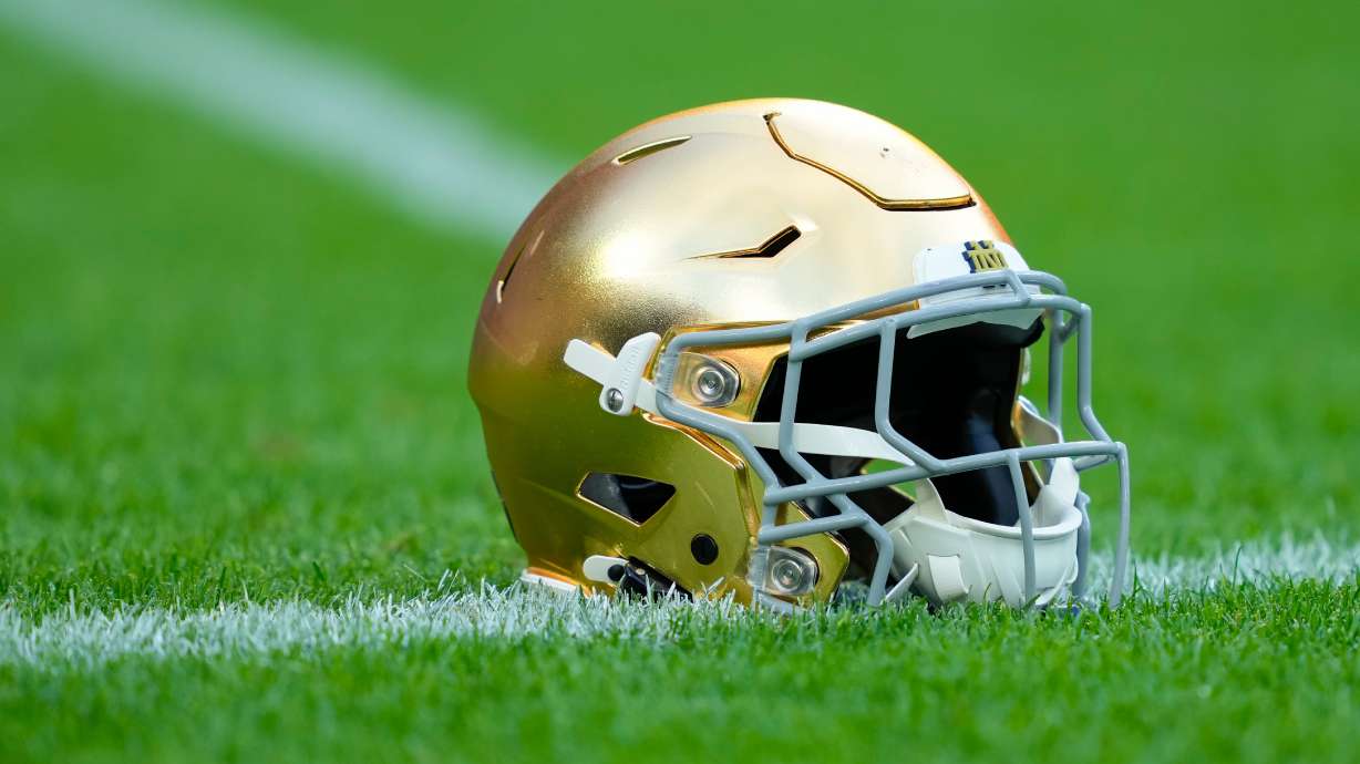 FILE - A Notre Dame helmet rests on the ground before an NCAA college football game against Wisconsin on Sept. 6, 2026, in Green Bay, Wis.