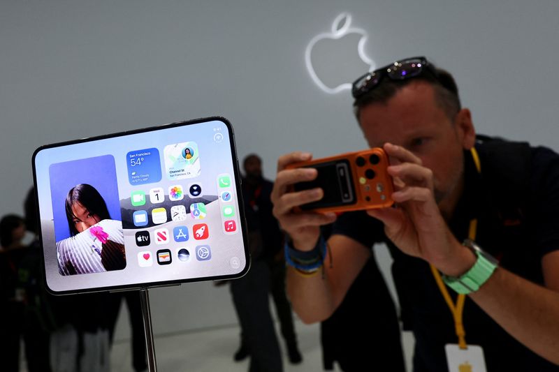 A man records images of the new foldable iPhone Duo on display during Apple's event at the Steve Jobs Theater in Cupertino, Calif., Wednesday. The Duo is the biggest change to the company's signature innovation.