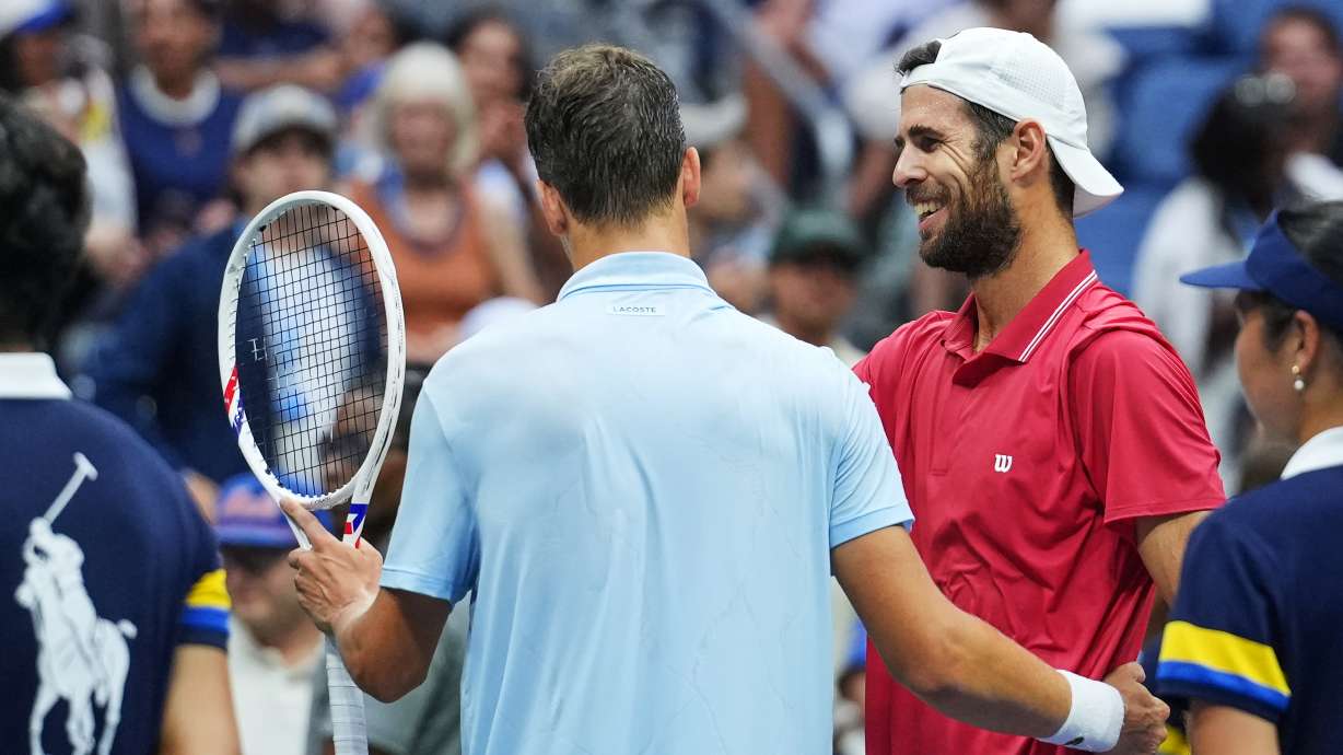 Alexander Blockx, of Belgium, left, meets Karen Khachanov, of Russia, at the net after Blockx was forced to retire due to an apparent injury during the quarterfinal round of the U.S. Open tennis championships, Wednesday, Sept. 9, 2026, in New York.