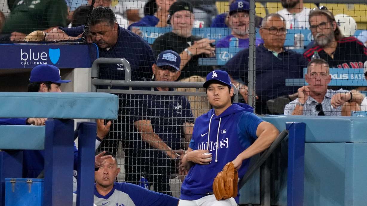 Los Angeles Dodgers' Shohei Ohtani watches from the dugout during the first inning of a baseball game against the Cincinnati Reds, Tuesday, Sept. 8, 2026, in Los Angeles.