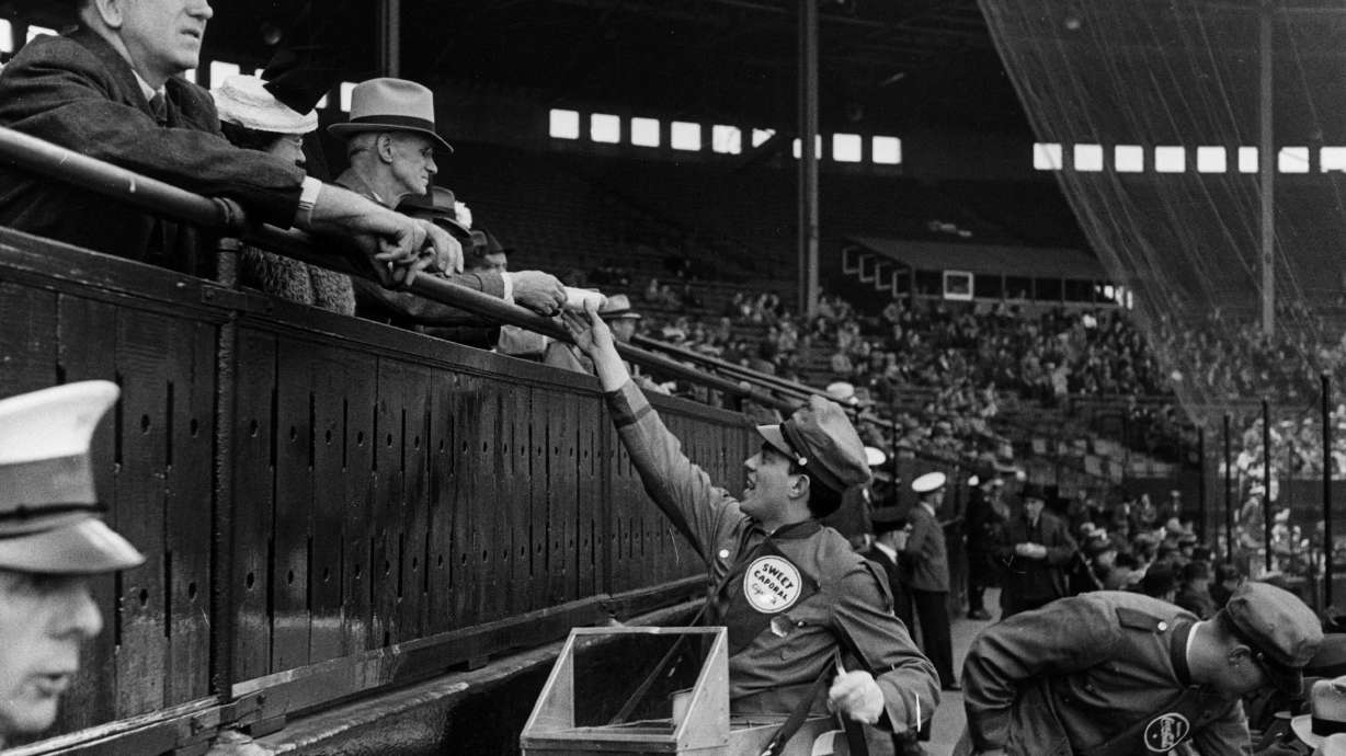 A hot dog seller distributes his goods at a Canadian baseball game in 1939.