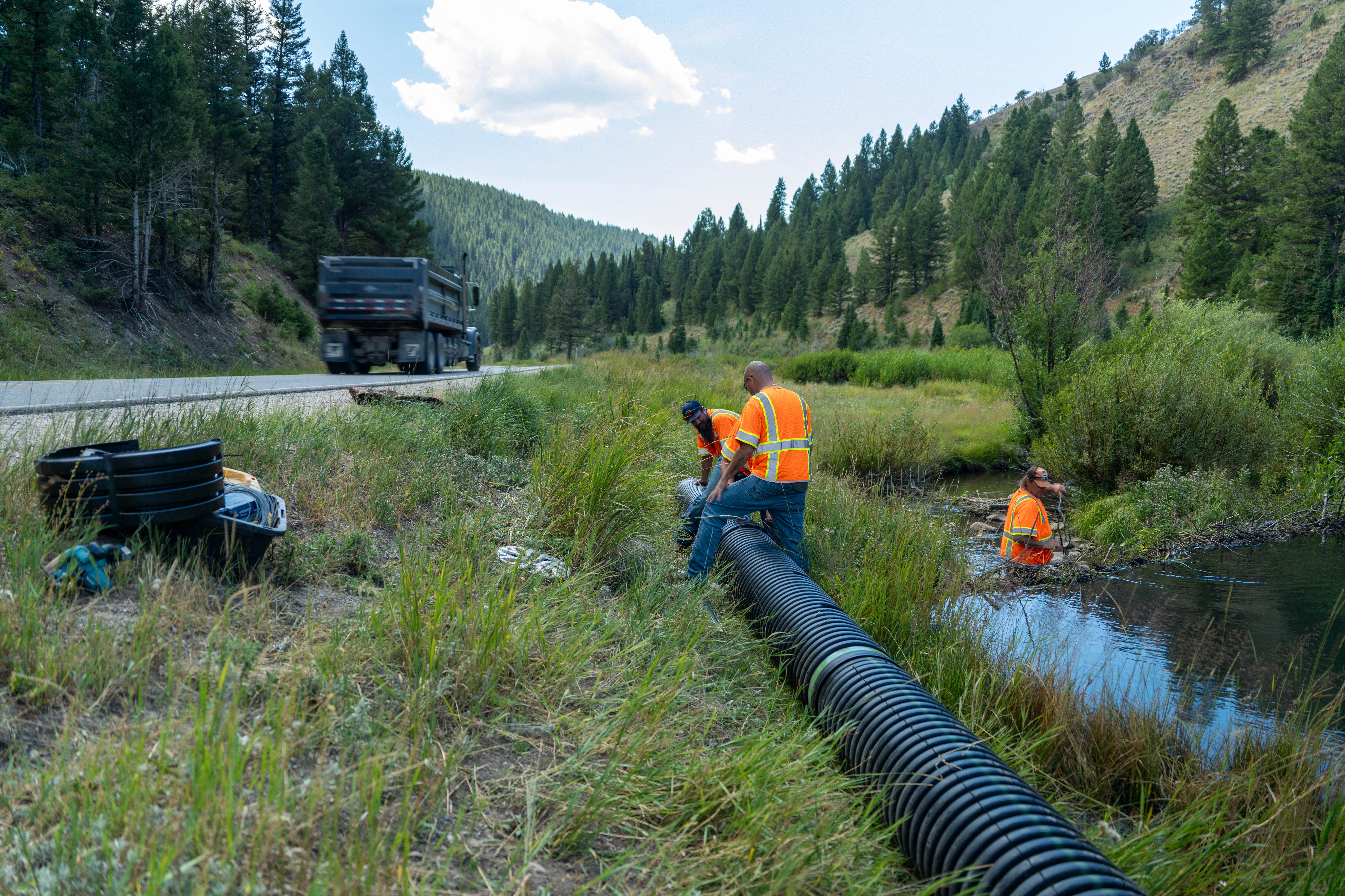 Utah transportation officials and local wildlife biologists install new pond levelers at a beaver dam along Beaver Creek in Logan Canyon. The state said Thursday that they've added three of them as part of a plan to reduce road damage while coexisting with beavers.