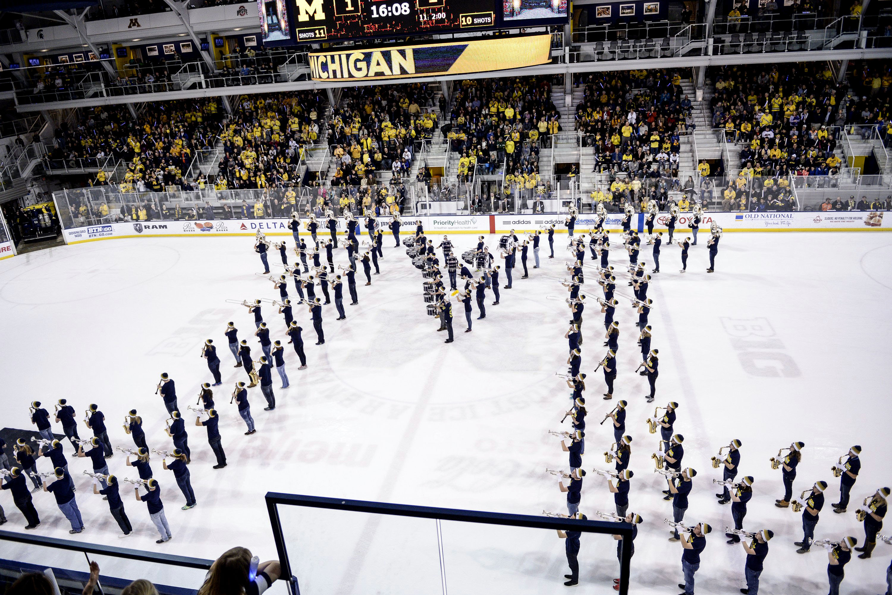 FILE - The Michigan Marching Band performs at the end of the first period during an NCAA college men's hockey game between Michigan State and Michigan, Jan. 9, 2016, in Ann Arbor, Mich. 