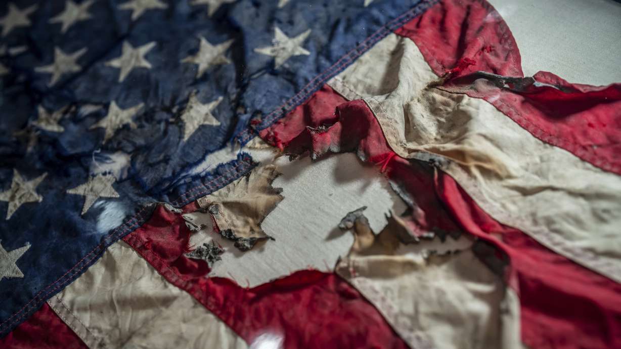 A badly damaged flag recovered from the World Trade Center debris is displayed at the Smithsonian's National Museum of American History, the nation's official repository for September 11 materials, in Washington, Thursday.