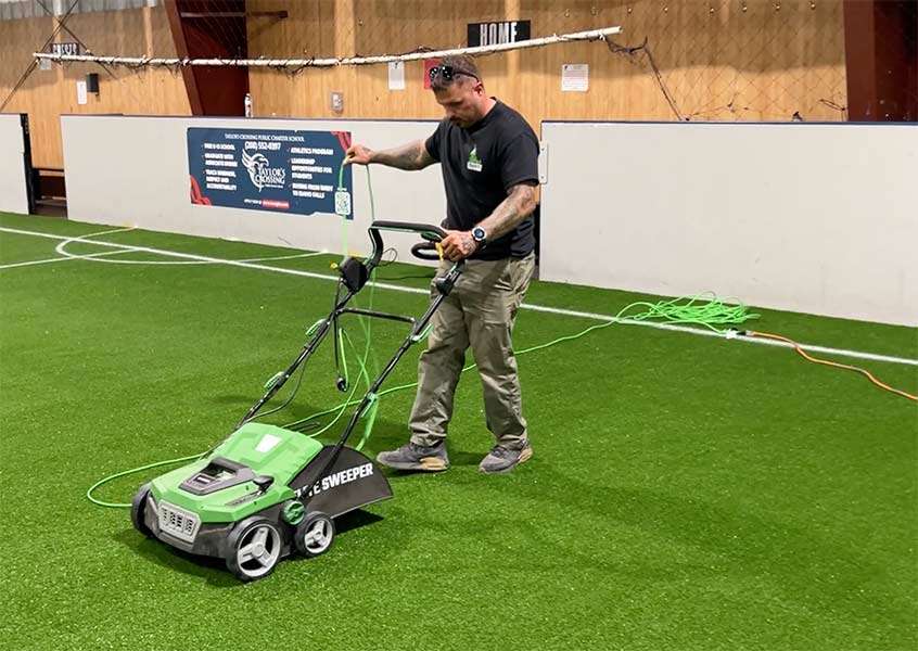 Ty Owen with Idaho Turf Co. sweeping the new turf at the Idaho Falls YMCA Indoor Soccer Complex on Tuesday, in preparation for the ribbon-cutting. Owen said Wednesday the turf's life expectancy is 16 years.