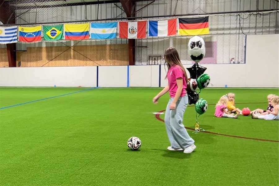 Woman kicking a soccer ball on the new turf at the Idaho Falls YMCA's Indoor Soccer Complex on Wednesday. Several fundraisers are planned for further upgrades at the facility.