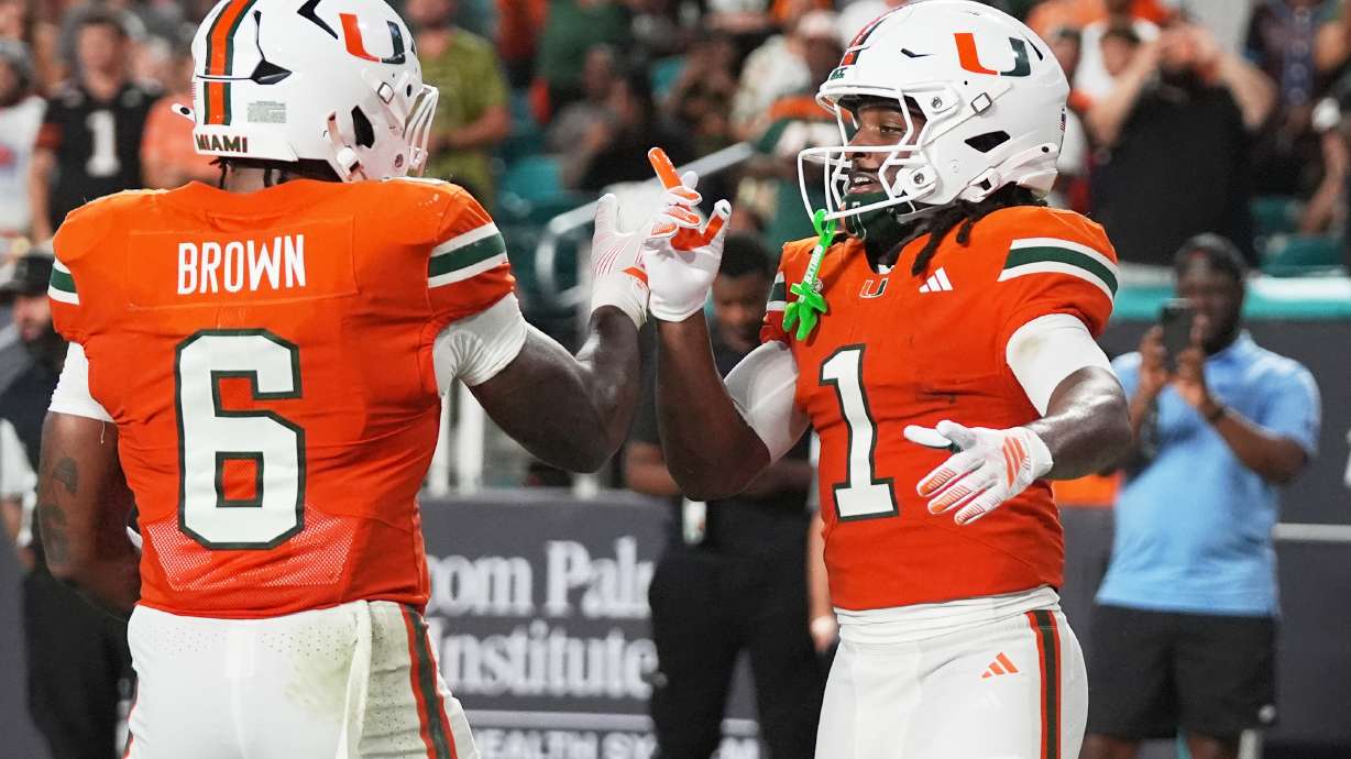 Miami wide receiver Malachi Toney (1) celebrates with running back Charmar Brown (6) after scoring a touchdown during the first half of an NCAA college football game against Florida A&M, Thursday, Sept. 10, 2026, in Miami Gardens, Fla.