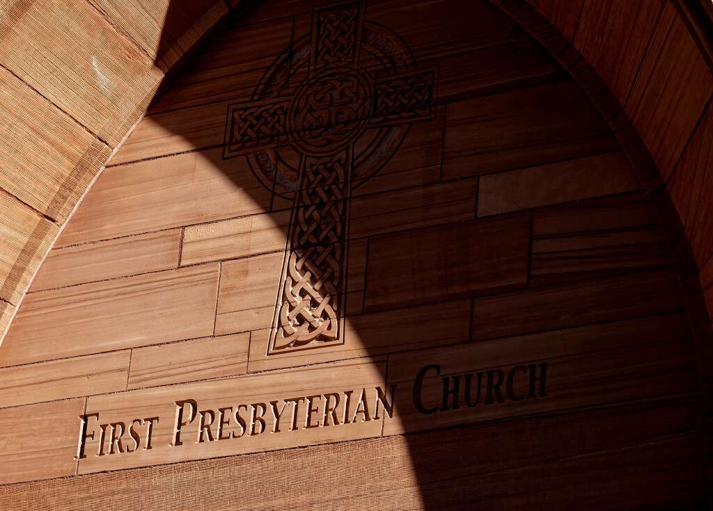 The First Presbyterian Church in Salt Lake City was built out of red sandstone and inscribed with a cross made of Celtic knots to honor its Scottish heritage. Shadows fall across the inscriptions on Wednesday morning.