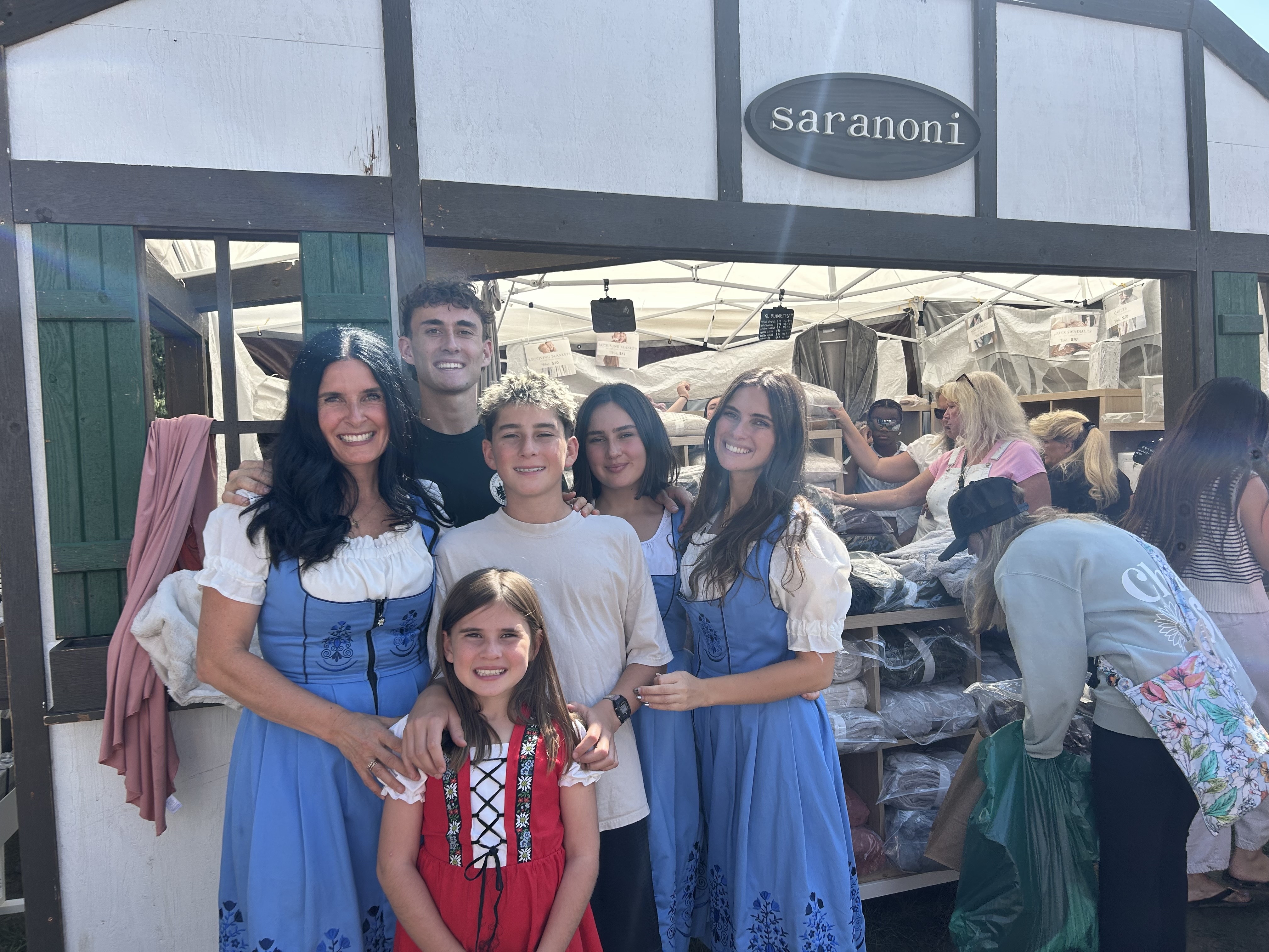 The Peterson family sells blankets for their company Saranoni at Swiss Days. The family has continued the tradition even after their father Nathan Peterson died from cancer.