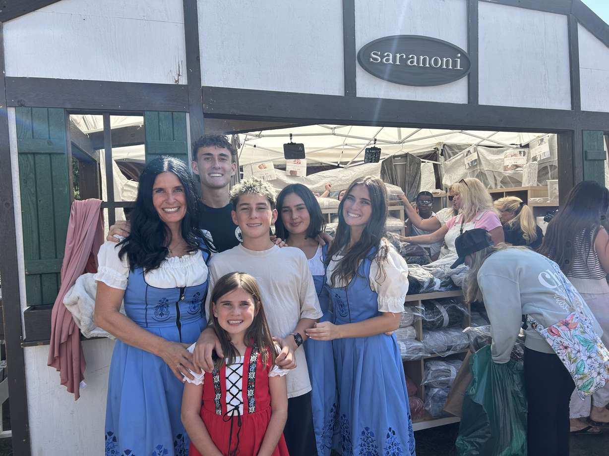 The Peterson family sells blankets for their company Saranoni at Swiss Days. The family has continued the tradition even after their father Nathan Peterson died from cancer.