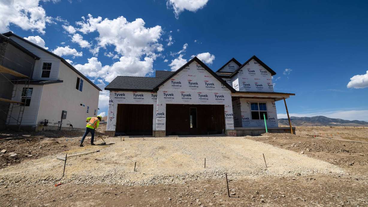 A construction worker builds a house in Herriman on Aug. 22. Mortgage rates have shot up beyond 7% for the first time in more than a year.