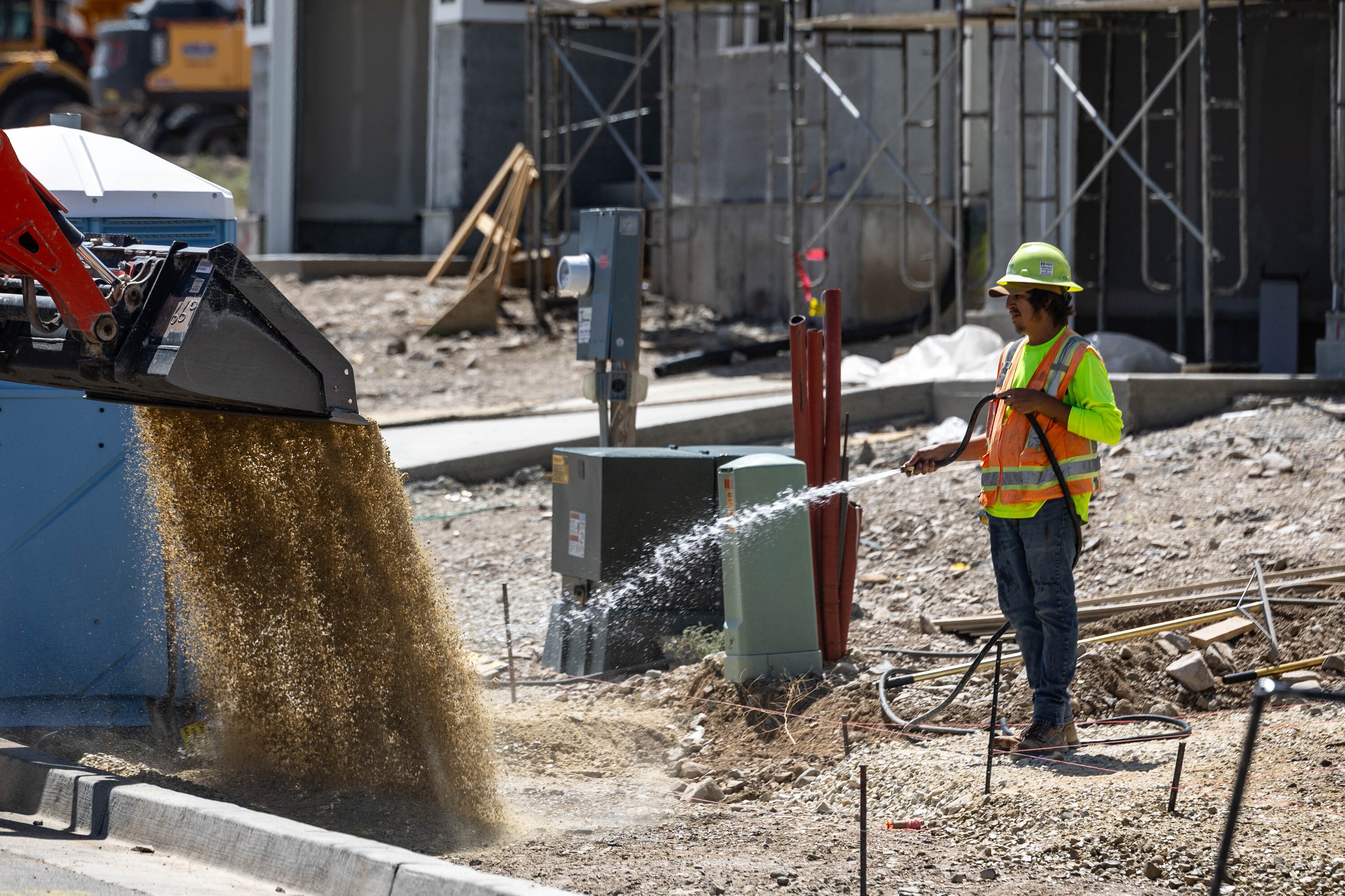 Construction workers build a house in Herriman on Aug. 22.