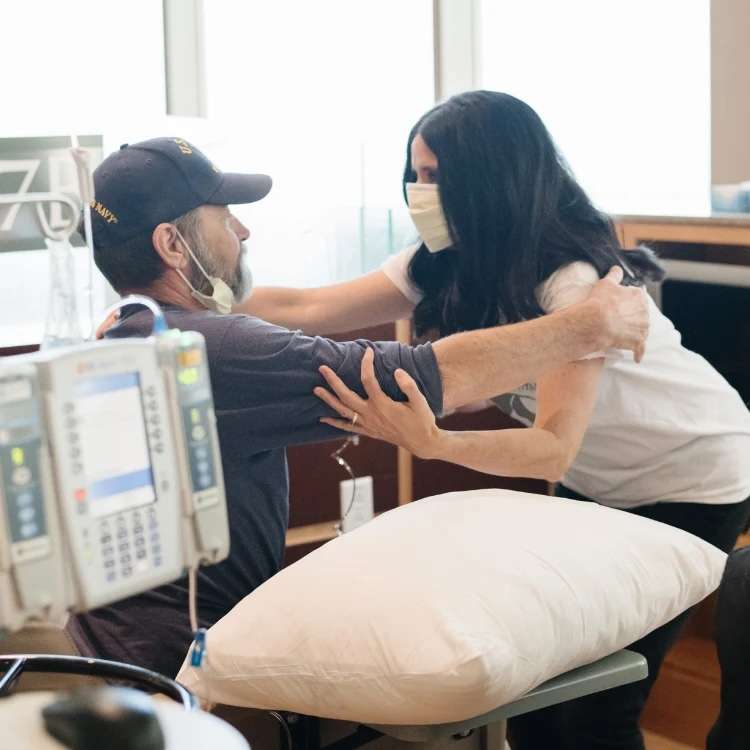 Emily Peterson, founder of Saranoni, hands out donated blankets to patients at Huntsman Cancer Institute. The Saranoni Cares program was started by her husband, who died of cancer a few months after starting the program.