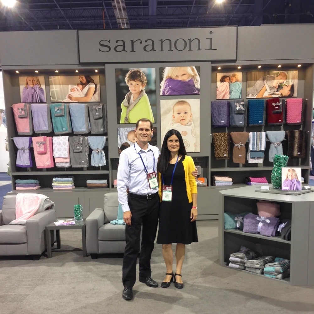 Saranoni founder Emily Peterson and her husband Nathan at their first trade show with their luxury blankets.