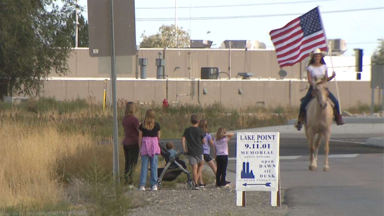 Cherade Allred rides her horse through Lake Point, Tooele County, in honor of 9/11 victims.
