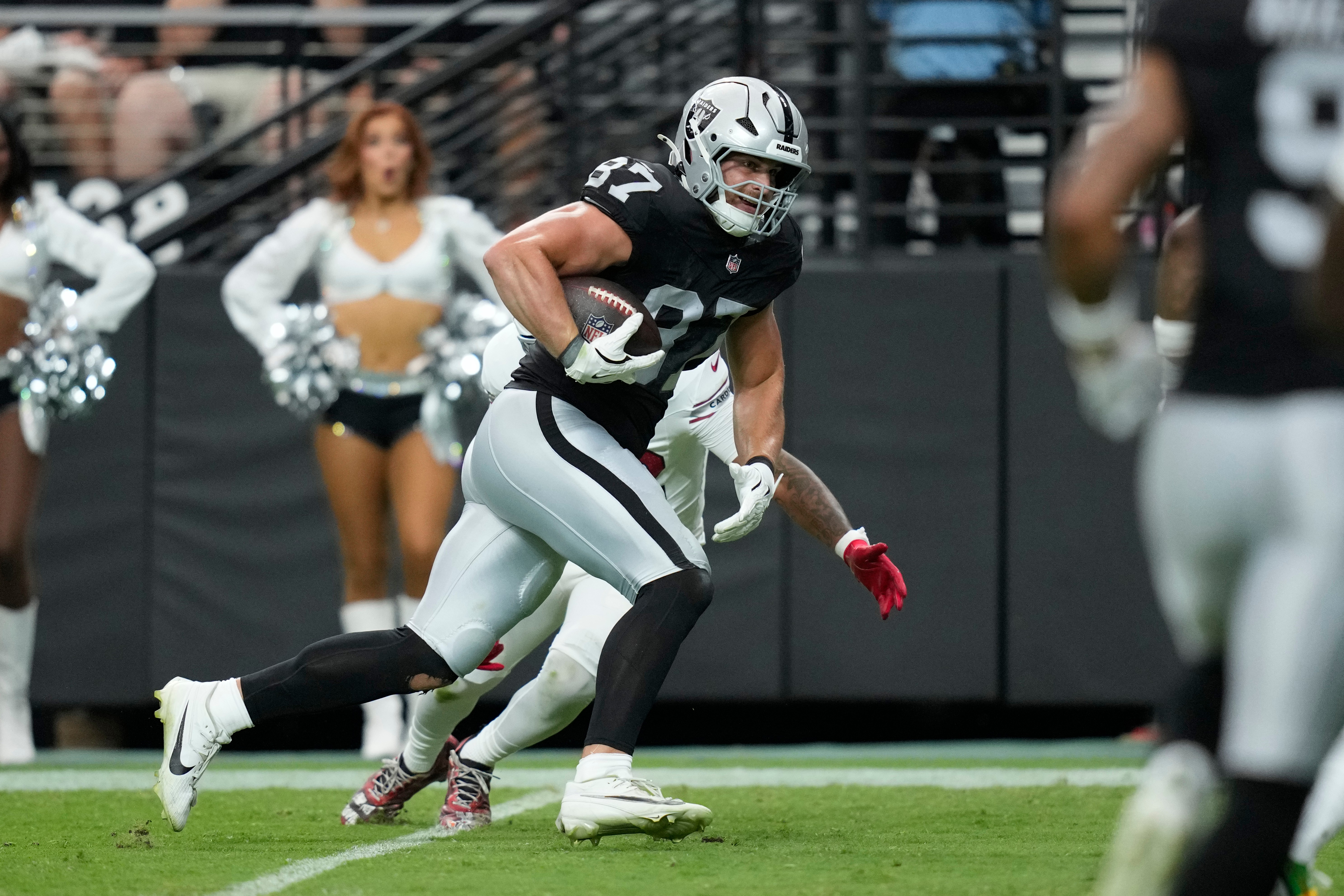 Las Vegas Raiders tight end Michael Mayer breaks away from the Arizona Cardinals defense to score a touchdown during the first half of a preseason NFL football game, Thursday, Aug. 13, 2026, in Las Vegas. 