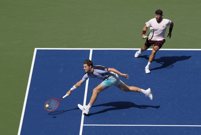 Tennis - U.S. Open - Flushing Meadows, New York, United States - September 12, 2026 Britain's Neal Skupski in action with Christian Harrison of the U.S during their doubles final against Germany's Kevin Krawietz and Germany's Tim Puetz