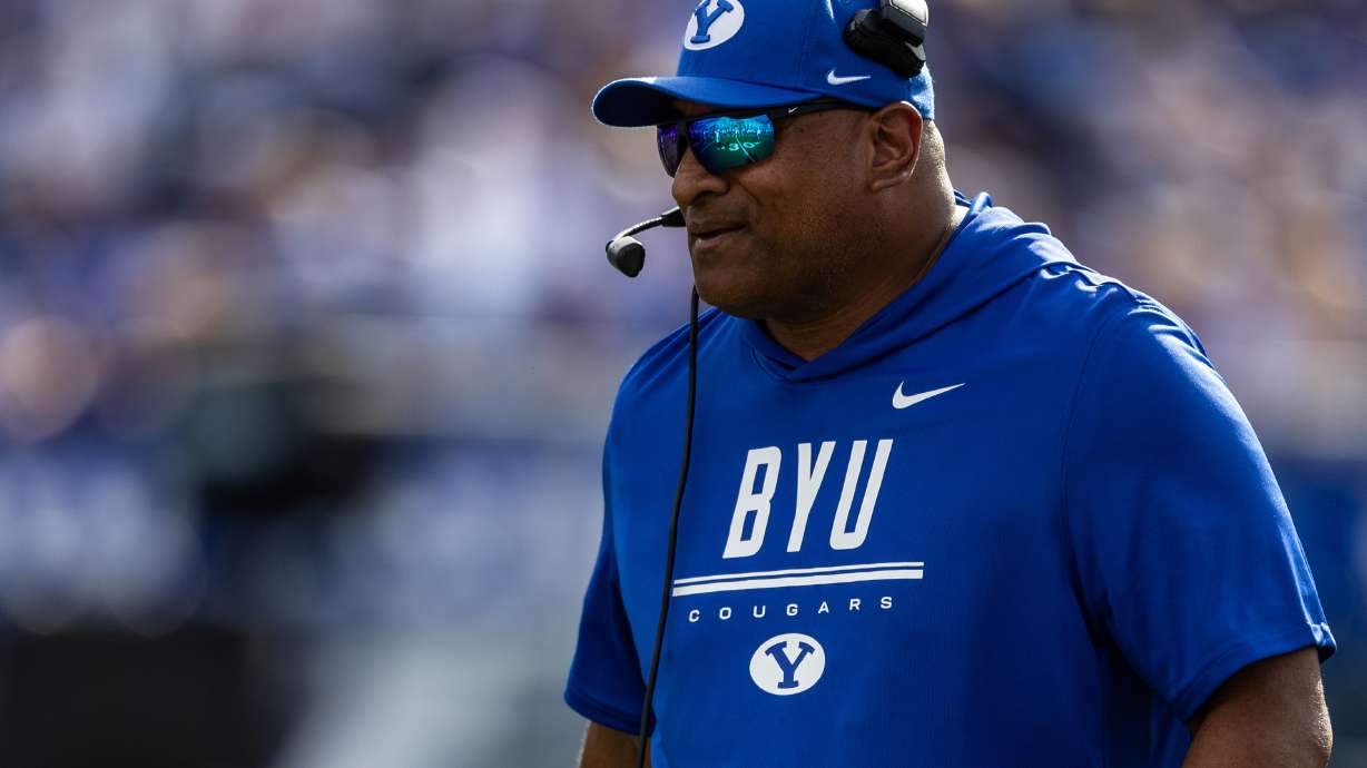 BYU Cougars head coach Kalani Sitake speaks into his headset during a football game against Arizona at LaVell Edwards Stadium in Provo on Saturday, Sept. 12, 2026.