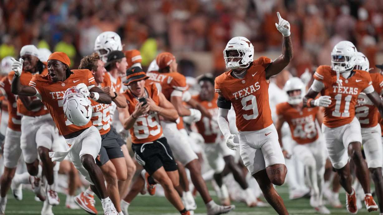 Texas players celebrate their win over Ohio State in an NCAA college football game in Austin, Texas, Saturday, Sept. 12, 2026.