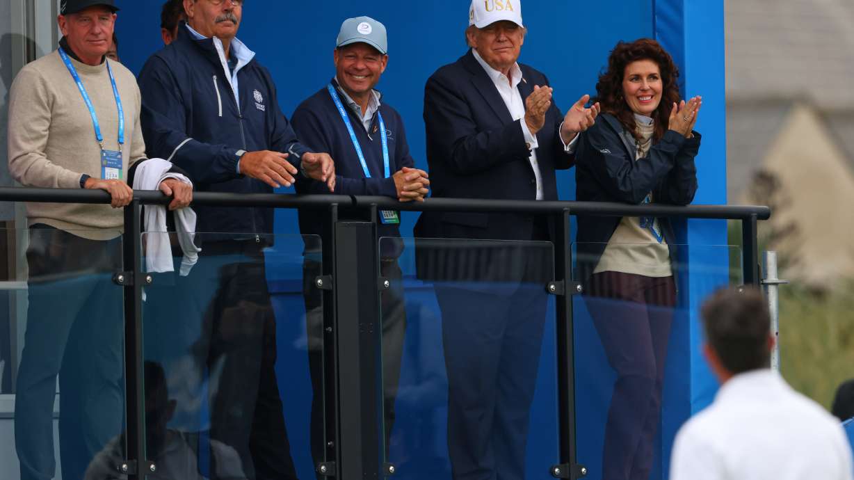 U.S. President Donald Trump applauds to golfer Rory McIlroy of Northern Ireland during the Irish Open at the Trump International Golf Links course in Doonbeg, Ireland, Saturday, Sept. 12, 2026.