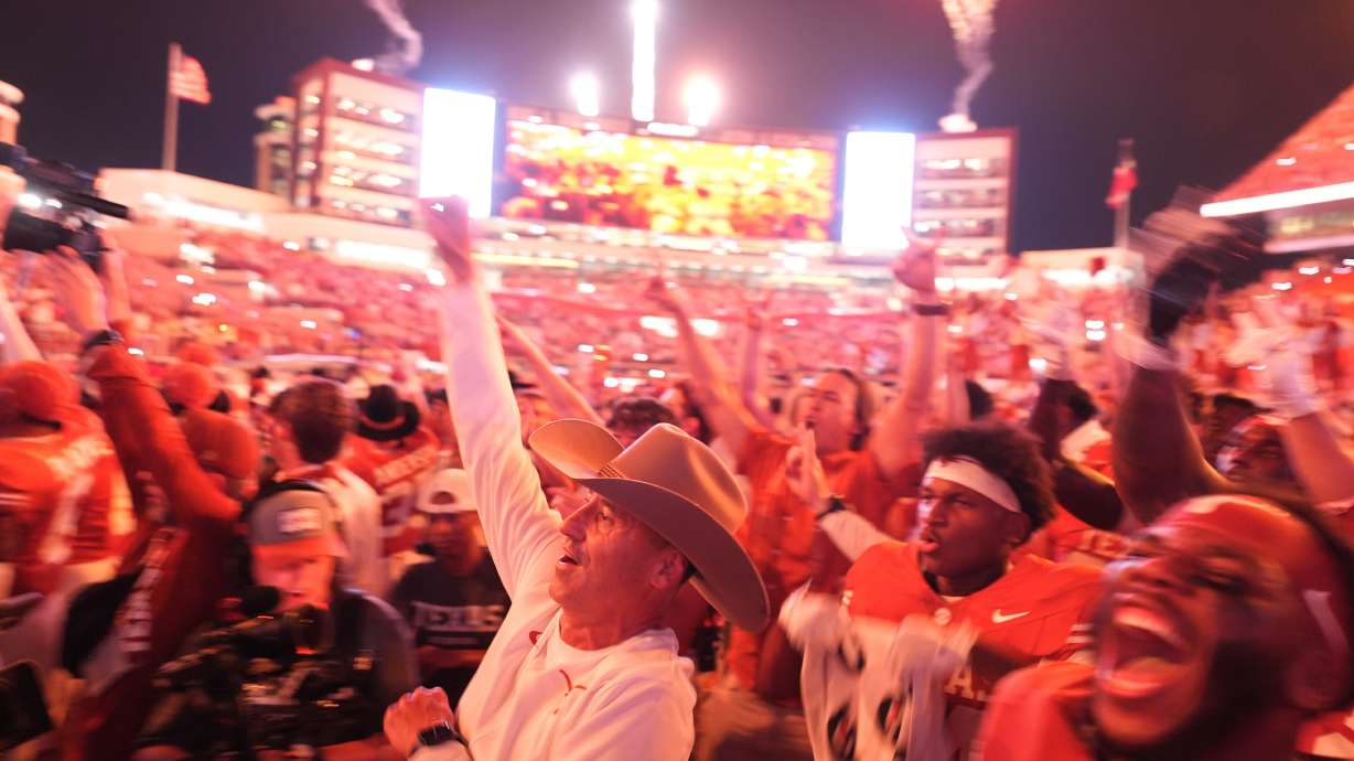 Texas head coach Steve Sarkisian, center and Texas players celebrate their win over Ohio State in an NCAA college football game in Austin, Texas, Saturday, Sept. 12, 2026.