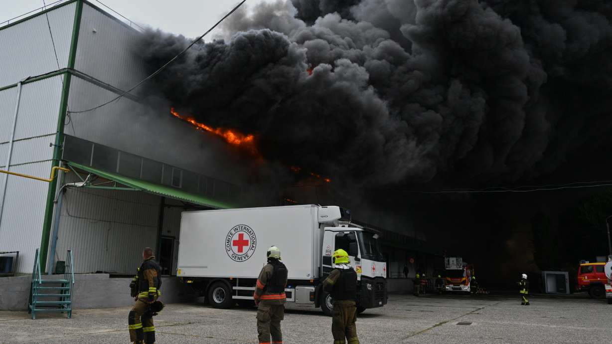 Firefighters put out a fire at warehouse stores after a Russian air attack in Odesa, Ukraine, on Sunday.