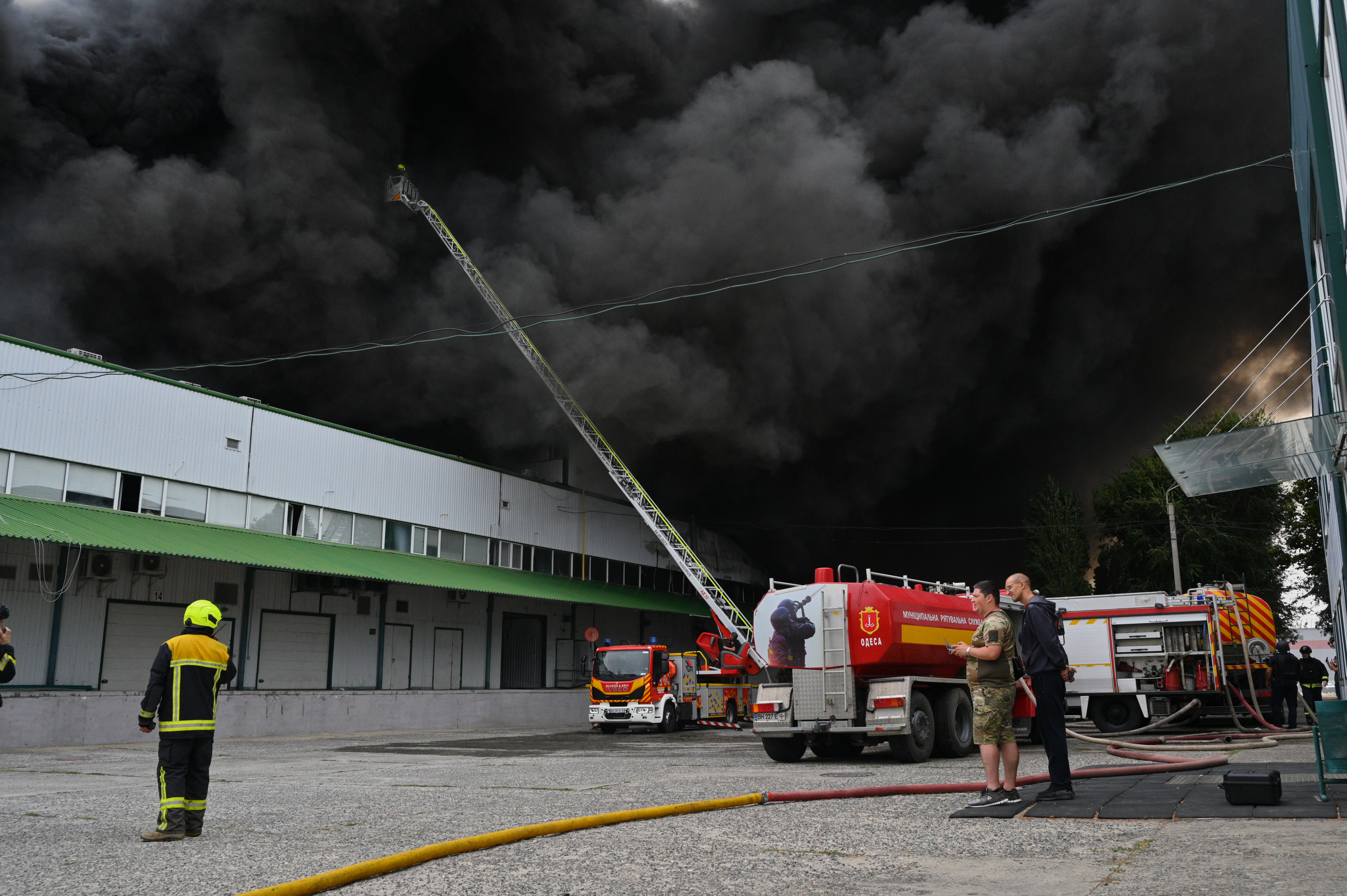 Firefighters put out a fire at warehouse stores after a Russian air attack in Odesa, Ukraine, Sunday.