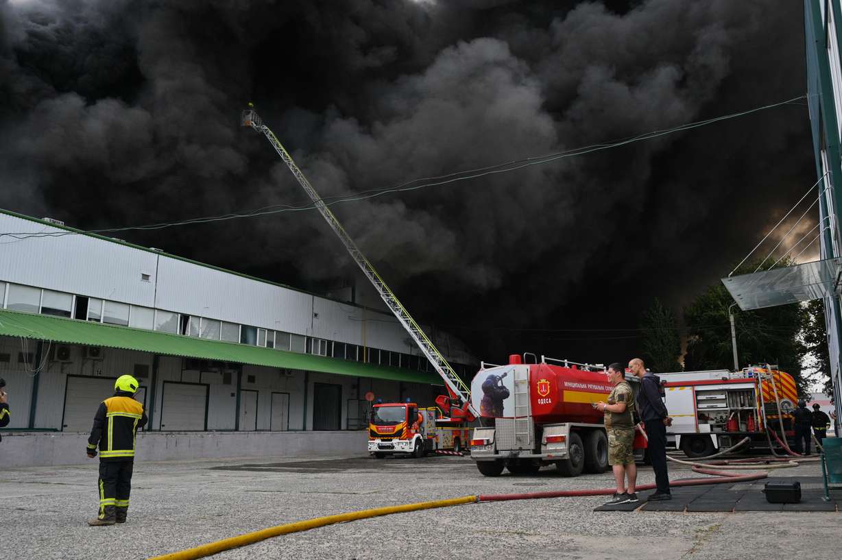 Firefighters put out a fire at warehouse stores after a Russian air attack in Odesa, Ukraine, Sunday.