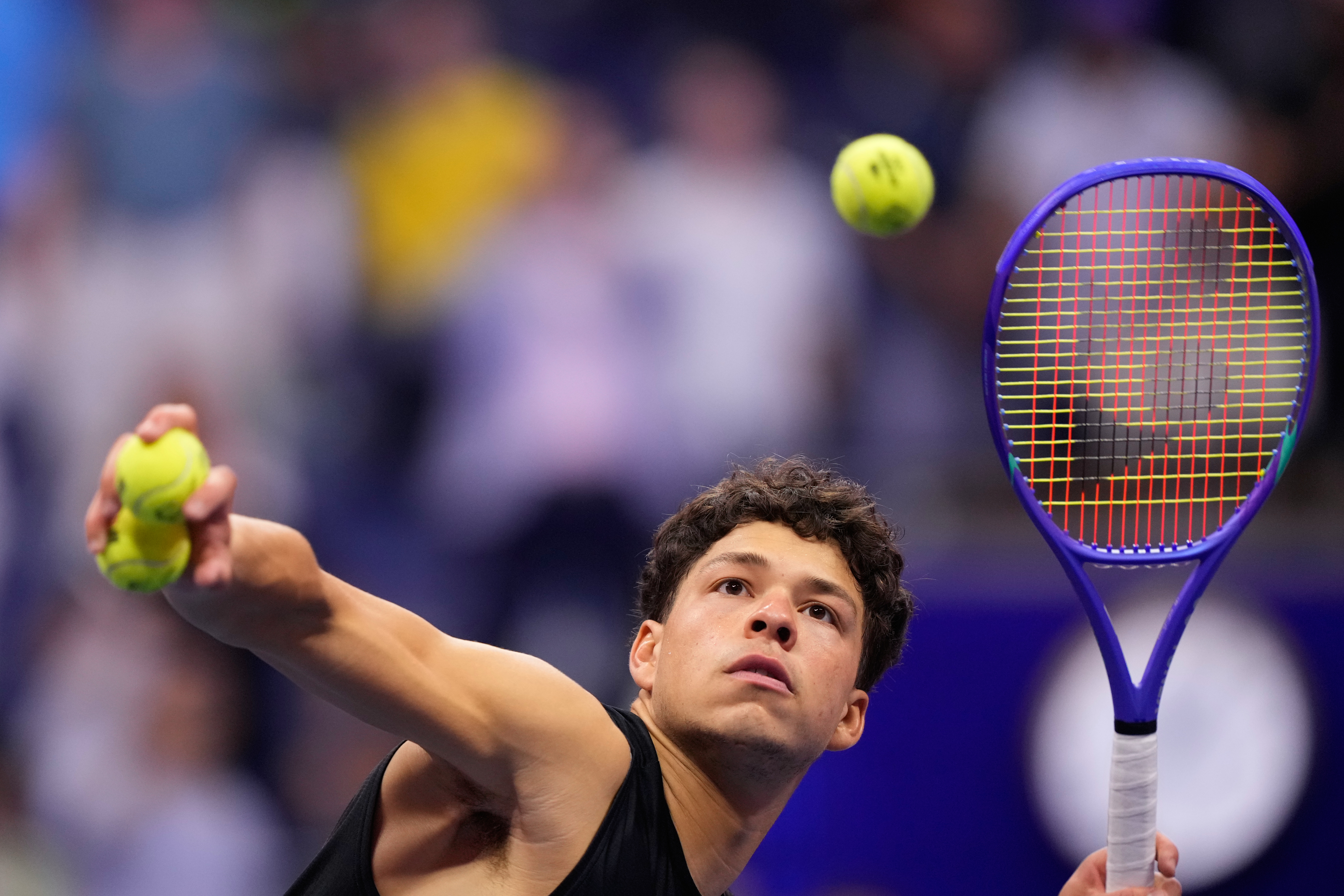 Ben Shelton, of the United States, hits balls to audience after he won his match against Frances Tiafoe, of the United States, during the men's singles semifinals of the U.S. Open tennis championships Friday, Sept. 11, 2026, in New York. 
