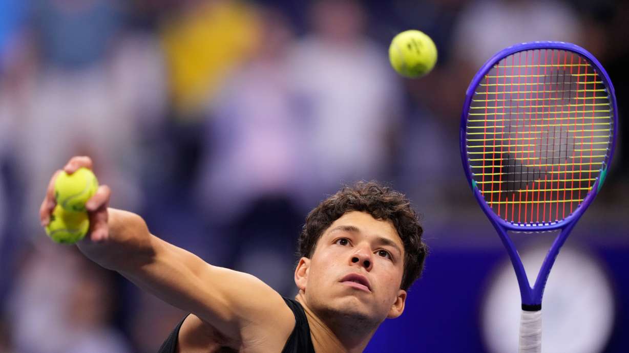 Ben Shelton, of the United States, hits balls to audience after he won his match against Frances Tiafoe, of the United States, during the men's singles semifinals of the U.S. Open tennis championships Friday, Sept. 11, 2026, in New York.