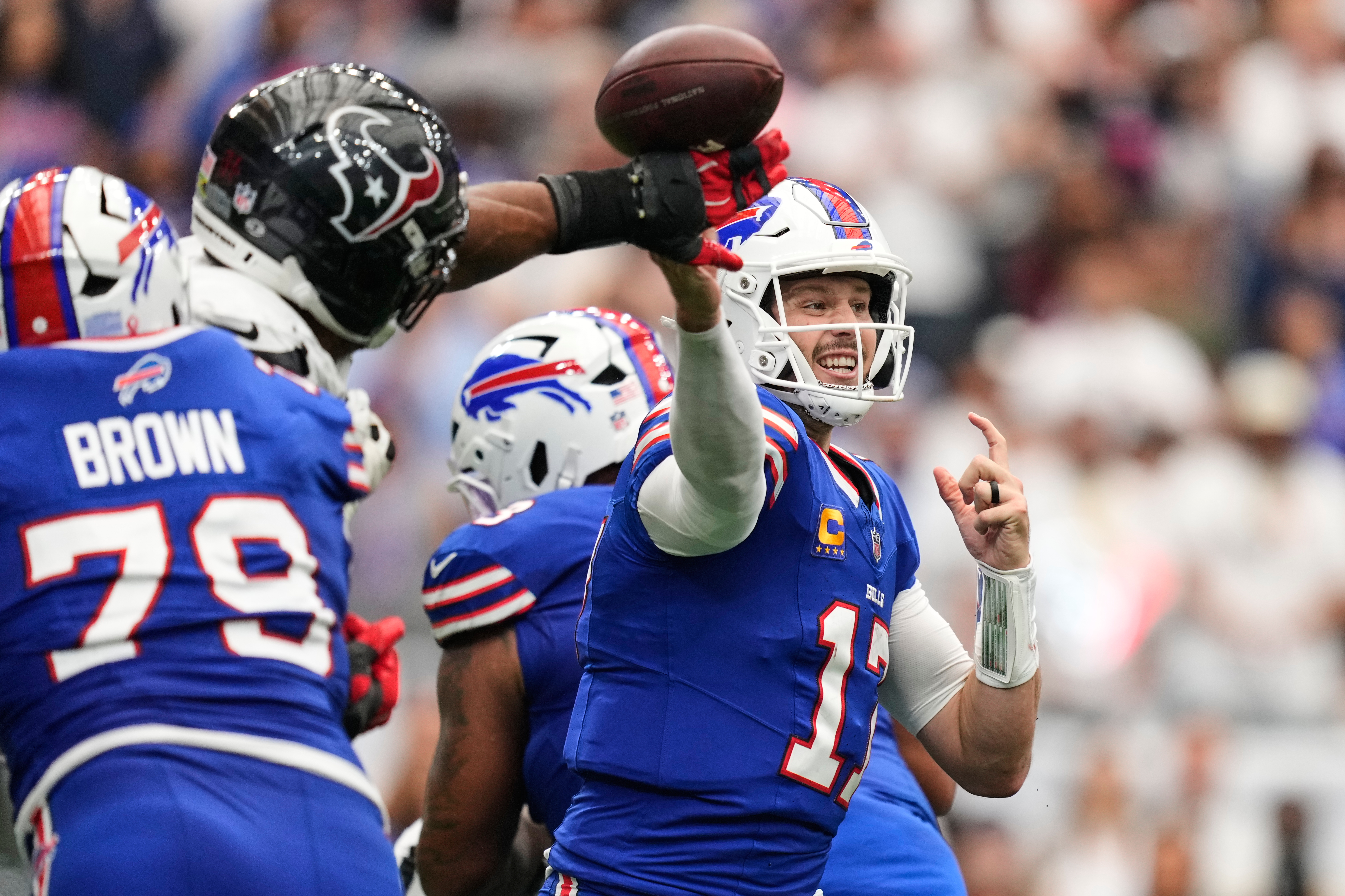 Buffalo Bills quarterback Josh Allen (17) throws an incomplete pass forced by Houston Texans defensive end Danielle Hunter, second from left, during the second half of an NFL football game, Sunday, Sept. 13, 2026, in Houston. 