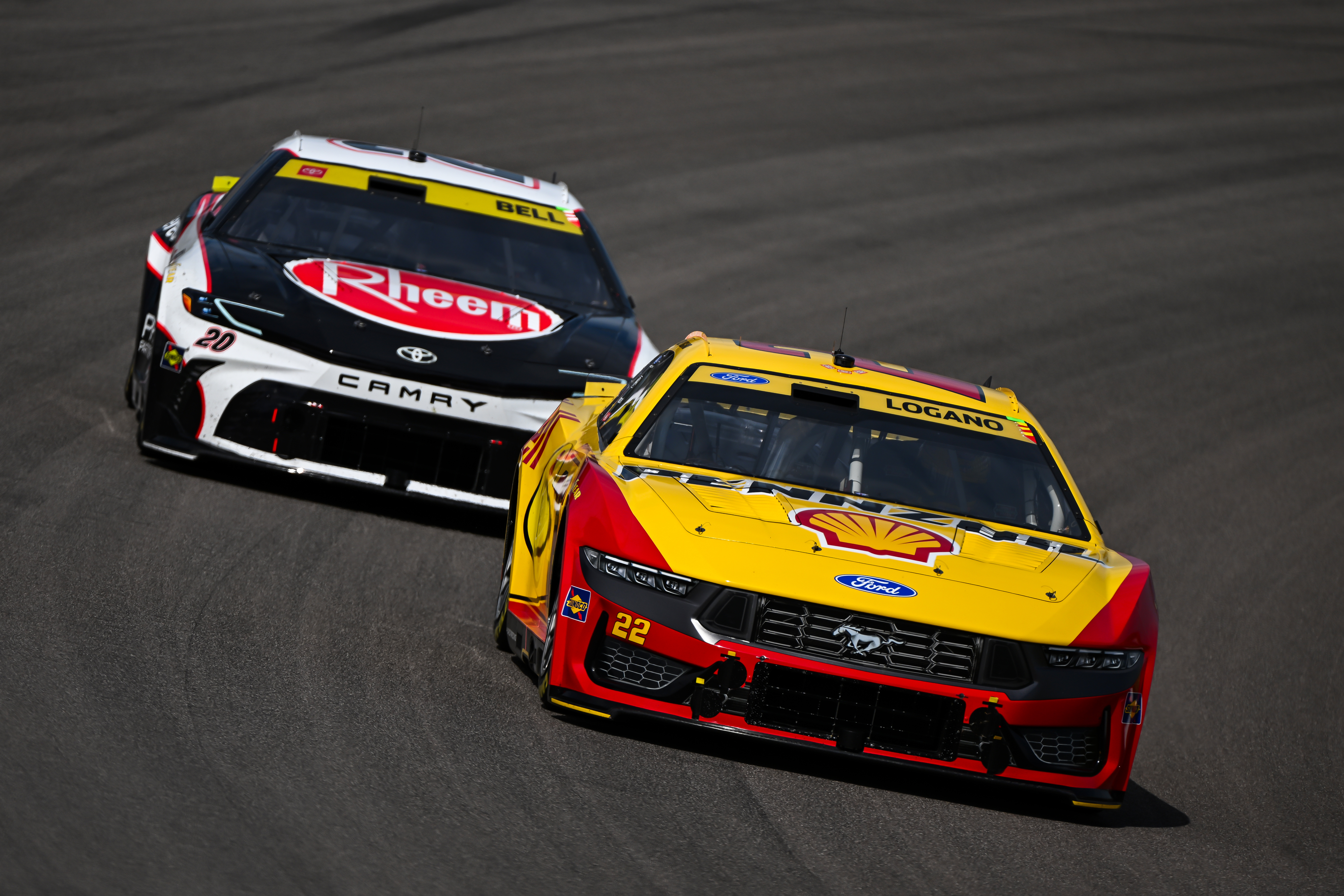 Christopher Bell (20) and Joey Logano (22) compete during a NASCAR Cup Series auto race Sunday, Sept. 13, 2026, in Madison, Ill. 