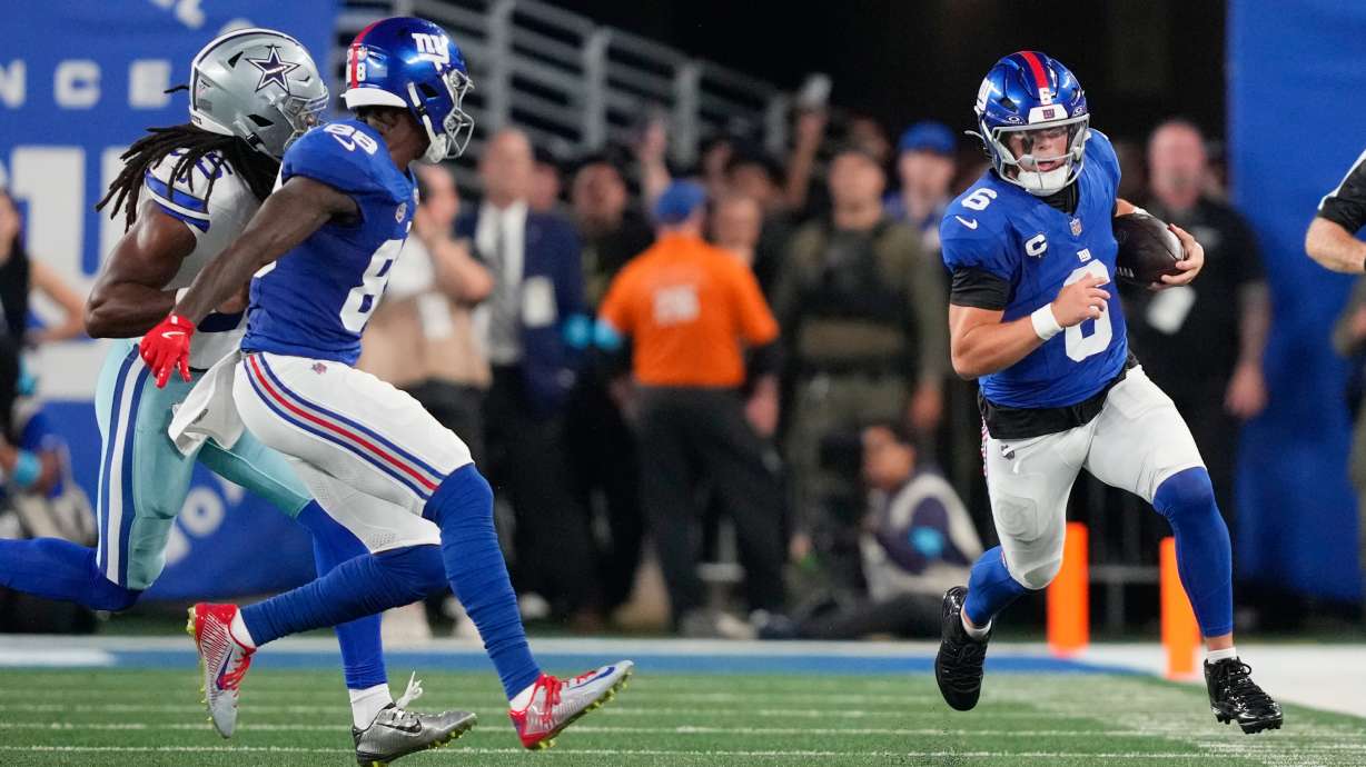 New York Giants quarterback Jaxson Dart, right, runs for yardage against the Dallas Cowboys during the first half of an NFL football game Sunday, Sept. 13, 2026, in East Rutherford, N.J.