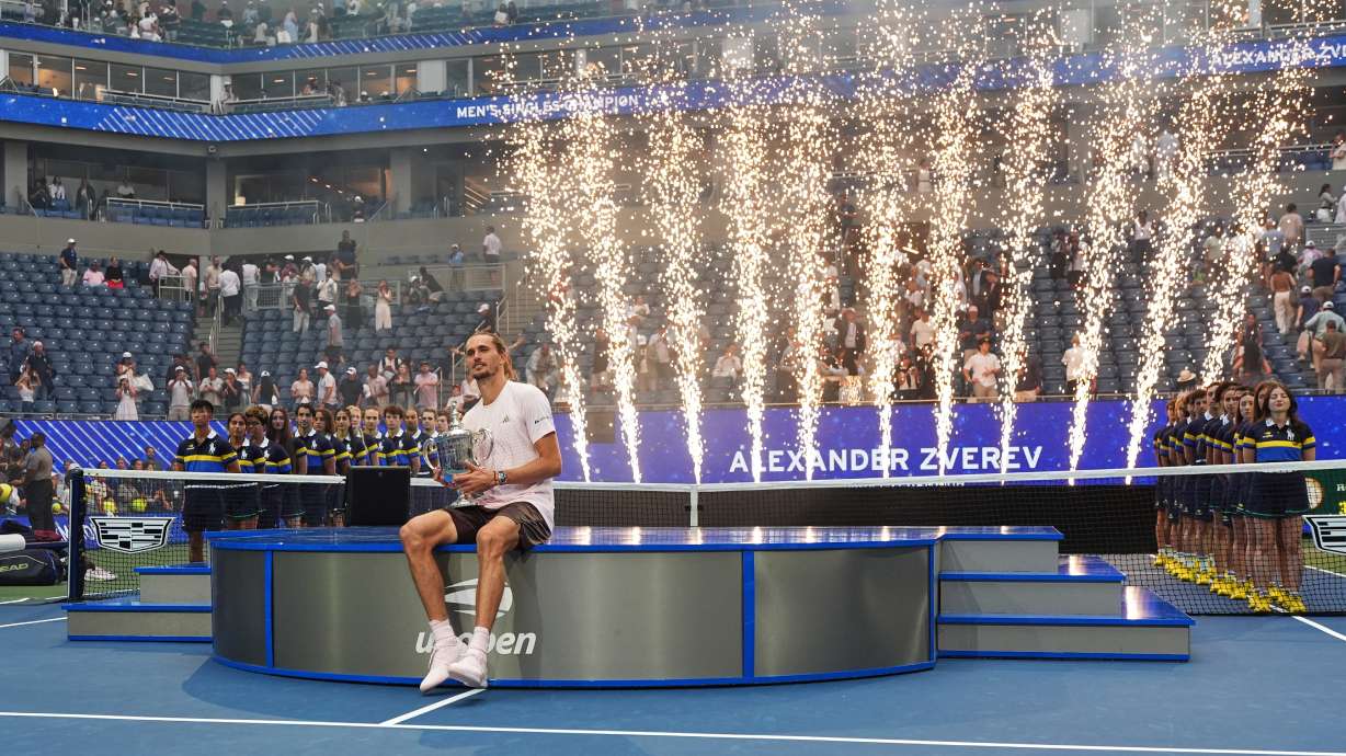 Alexander Zverev, of Germany, holds his trophy after winning the men's singles final of the U.S. Open tennis championships against Ben Shelton, of the United States, Sunday, Sept. 13, 2026, in New York.