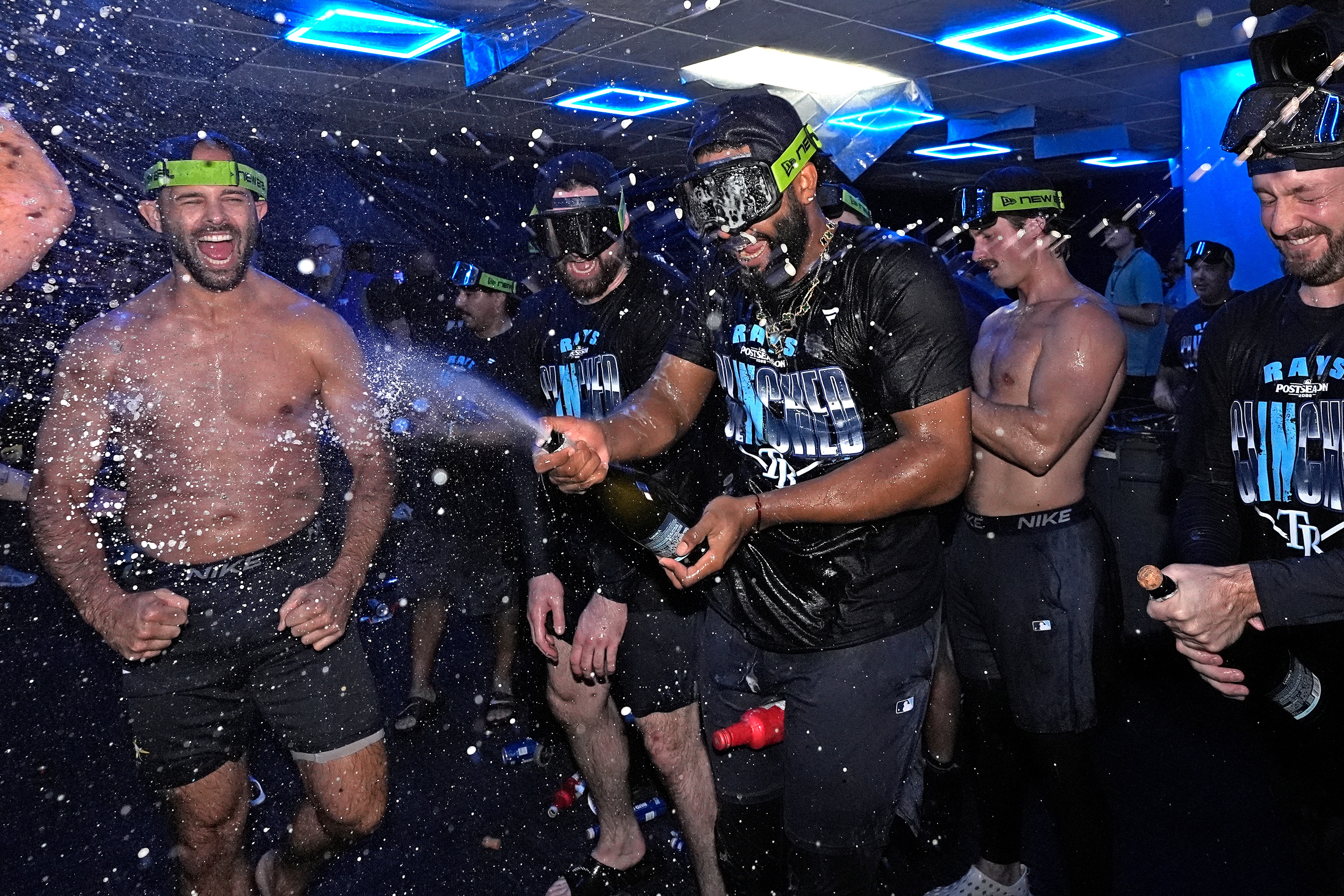 Tampa Bay Rays' Junior Caminero spreays champagne on teammates after the team clinched a playoff spot with a win over the Houston Astros during a baseball game Friday, Sept. 11, 2026, in St. Petersburg, Fla. 