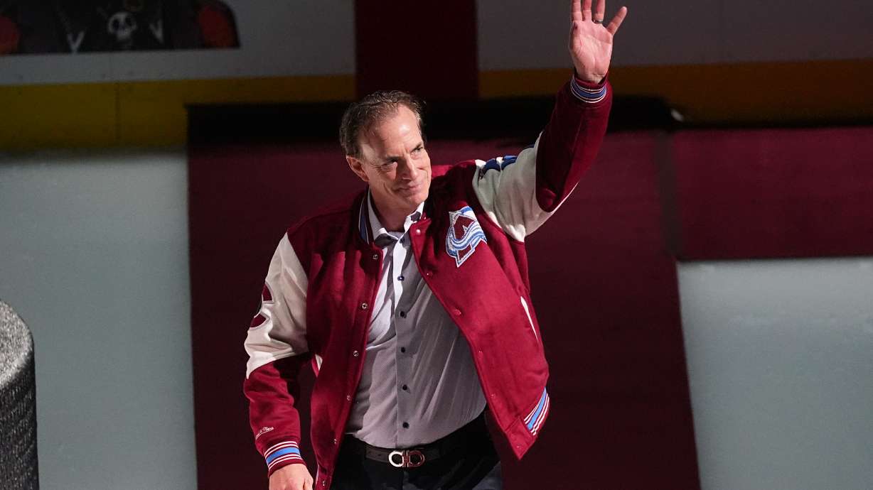 FILE - Joe Sakic, current general manager of the Colorado Avalanche as well as a member of the 1996 Stanley Cup Championship team, waves as he is introduced during a ceremony to mark the 30th anniversary of the win before an NHL hockey game against the Florida Panthers, on Dec. 11, 2025, in Denver.