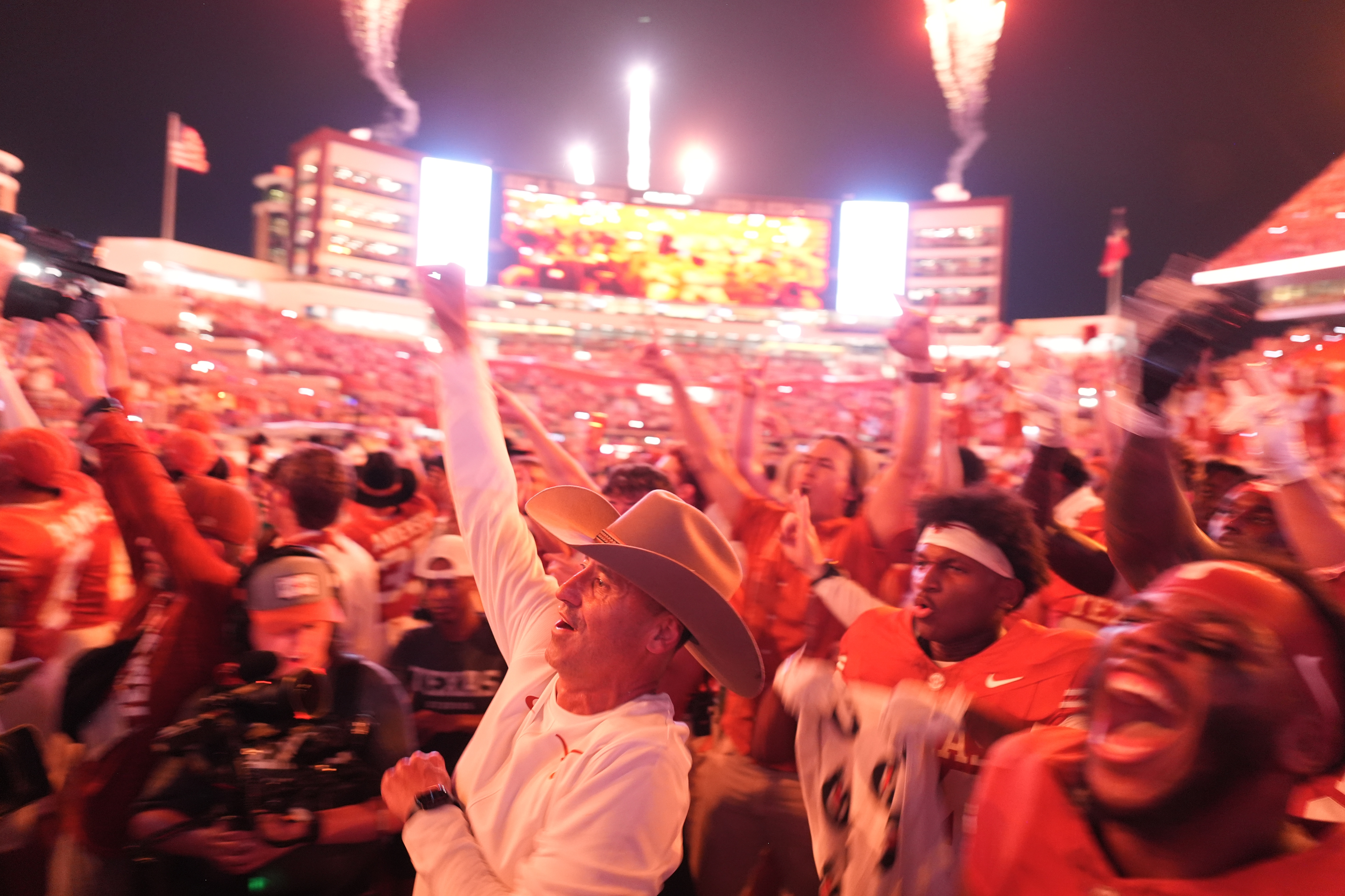 Texas head coach Steve Sarkisian, center and Texas players celebrate their win over Ohio State in an NCAA college football game in Austin, Texas, Saturday, Sept. 12, 2026. 