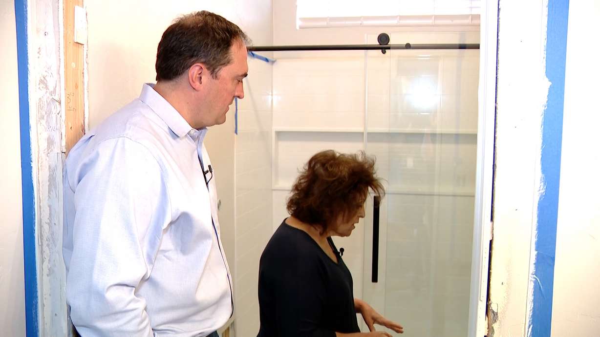 Jensen shows KSL's Matt Gephardt the damage caused to her home by multiple sewage backups in the building's shared sewer line.