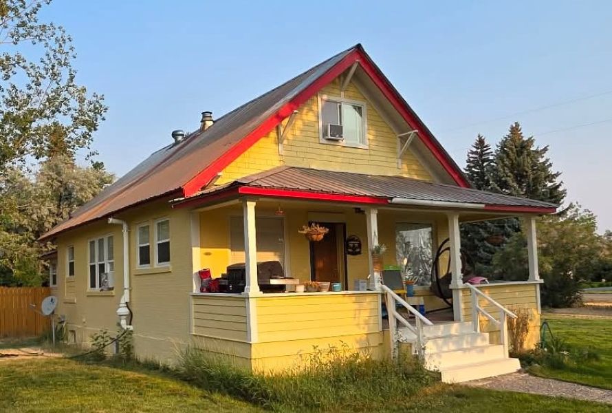 A photo of an old home provides the reference Jonah Saunders uses to create a detailed miniature replica of the building.