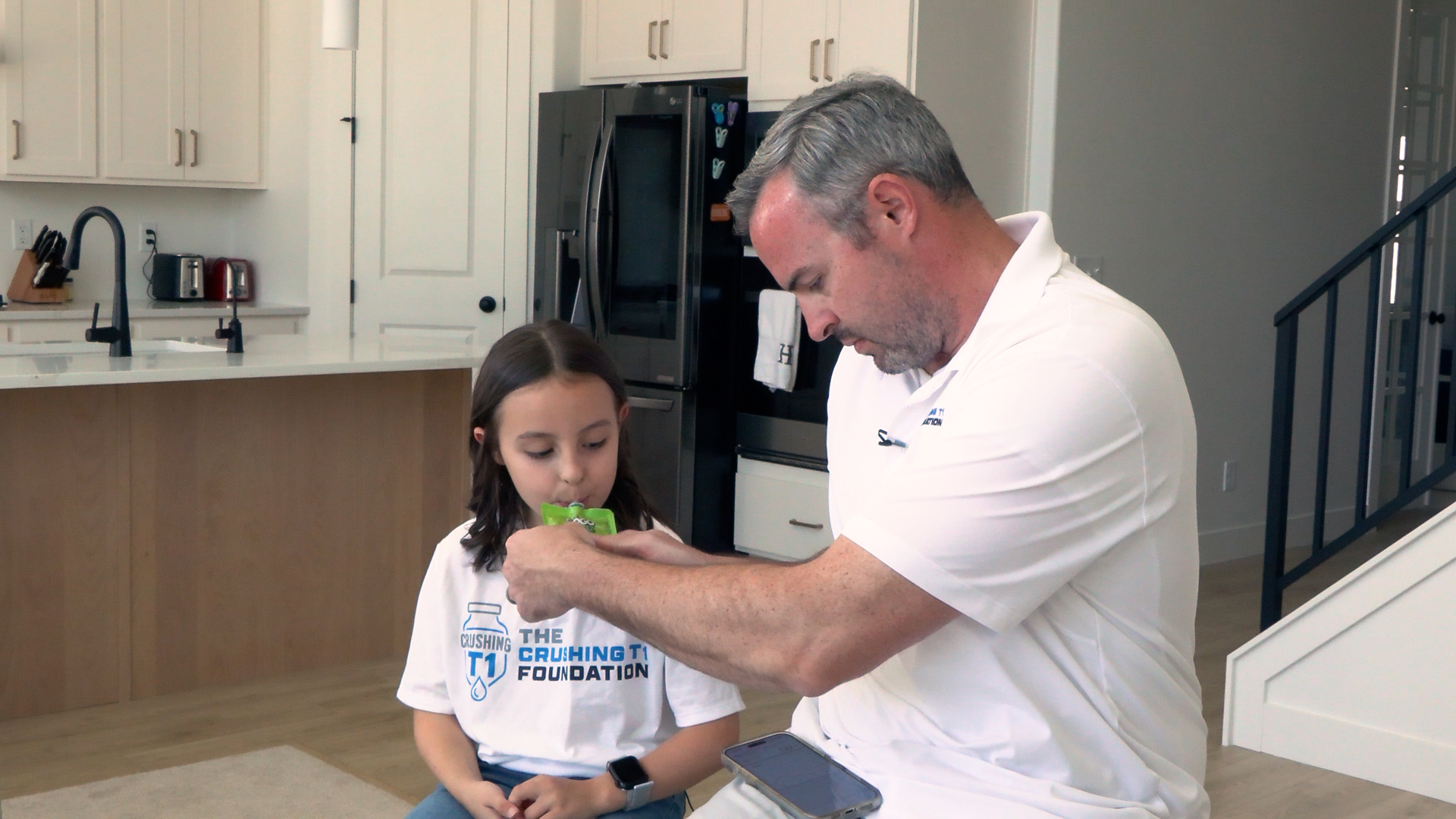 Devin Holt helps his daughter, Caroline, manage her Type 1 diabetes at home.