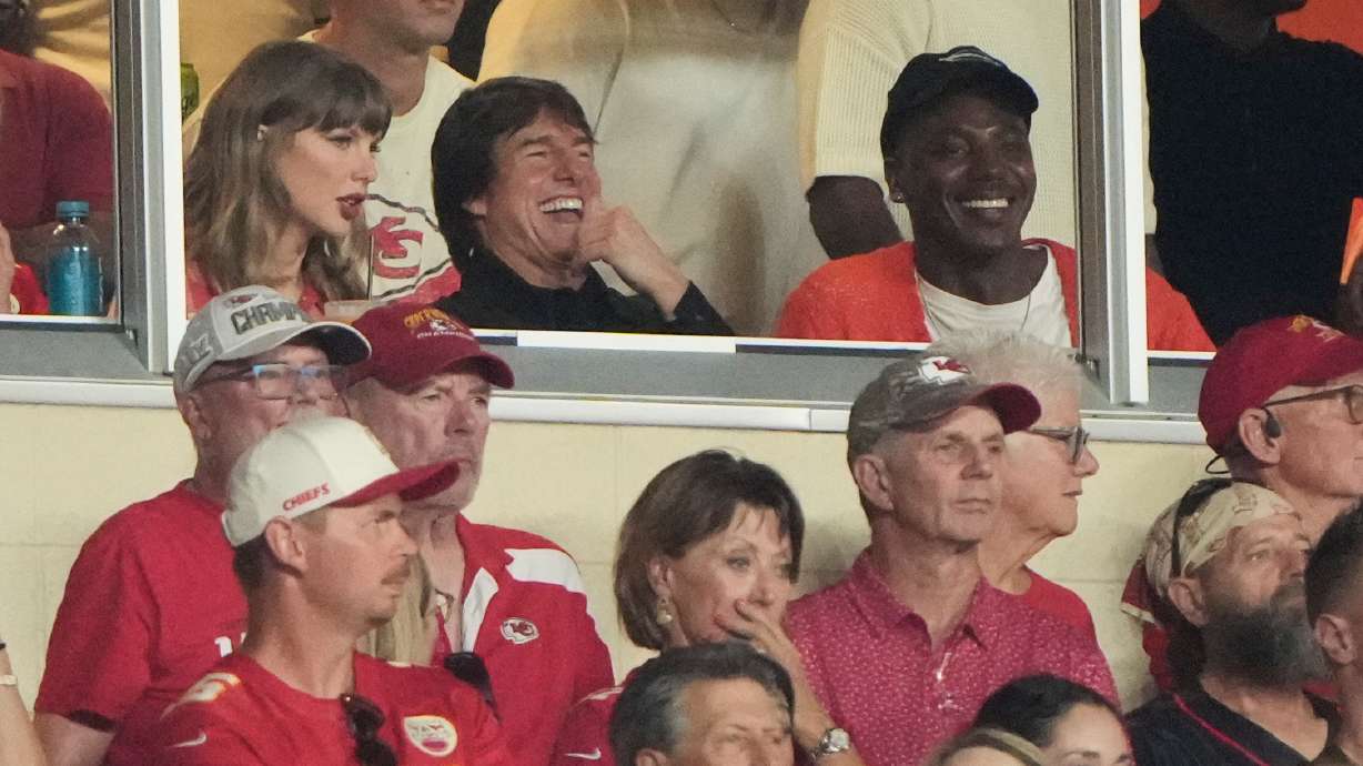 Taylor Swift, left, sits with Tom Cruise, center, while watching the first half of an NFL football game between the Kansas City Chiefs and the Denver Broncos, Monday, Sept. 14, 2026, in Kansas City, Mo.
