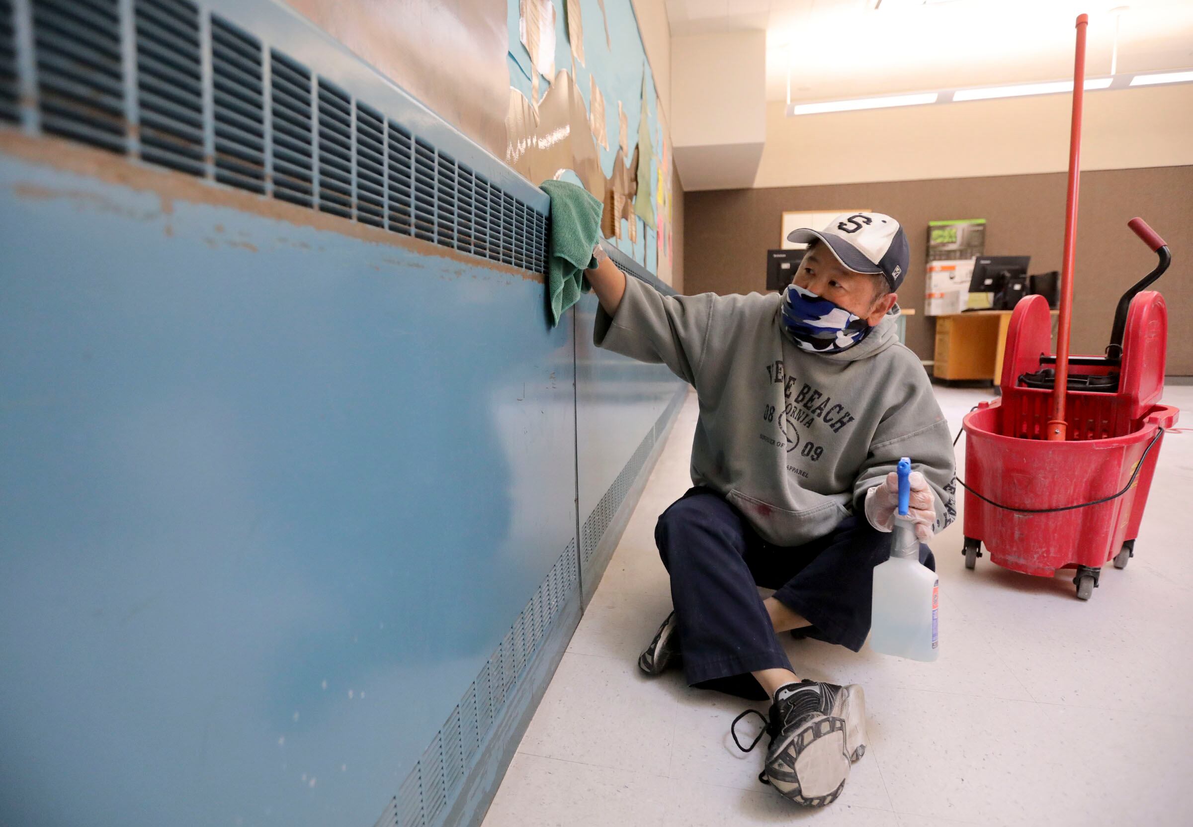 Michael Lee, Skyline High School custodian, cleans a classroom to get ready for the start of school at Skyline High School in Millcreek on July 23, 2020.