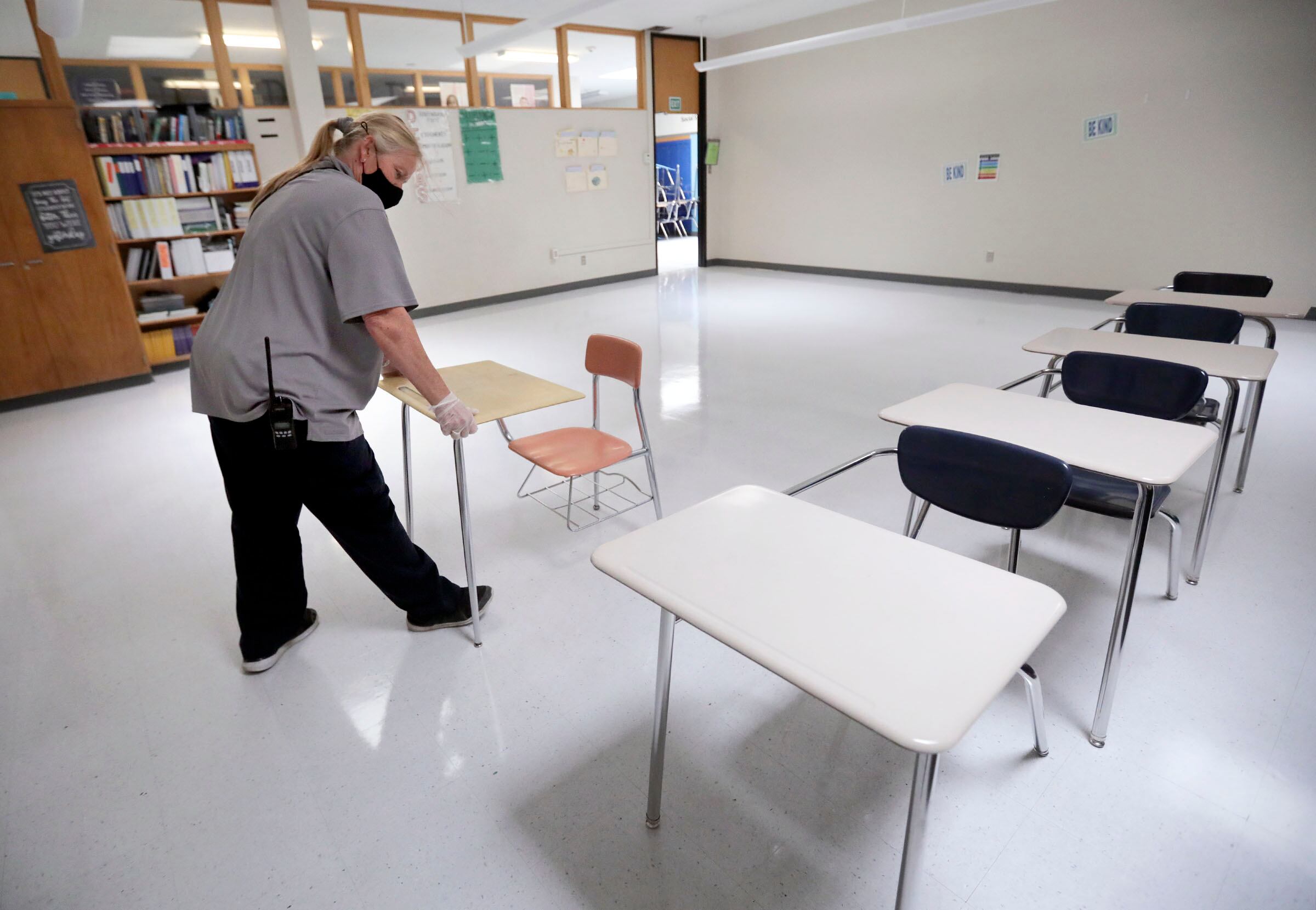 Stephanie Harrill, Skyline High School custodian, sets up desks in a cleaned classroom to get ready for the start of school at Skyline High School in Millcreek on July 23, 2020.
