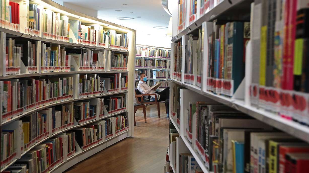 A man reads a book in a public library in Singapore on March 19, 2020. The nation is nudging people towards reading in an effort to combat "brain rot."