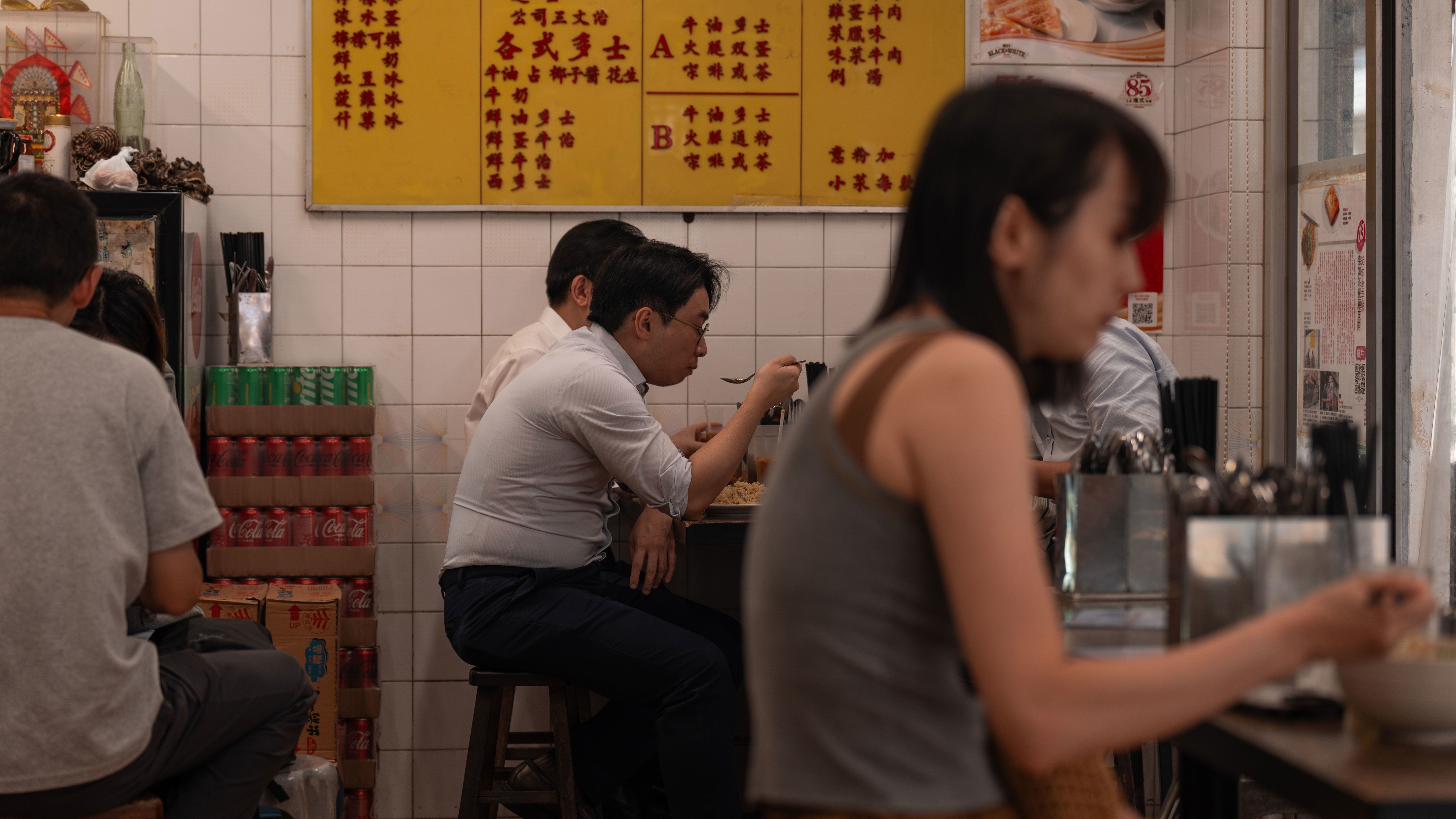 Traditional Hong Kong diners like Tak Yu, pictured, are famous for their controlled chaos.