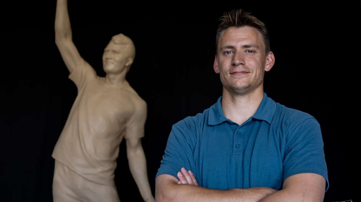 Quintin McCann poses with his original clay mold of Charlie Kirk at his home in Eagle Mountain on Monday. The real statue at Turning Point USA's headquarters was recently vandalized, prompting McCann to speak out.