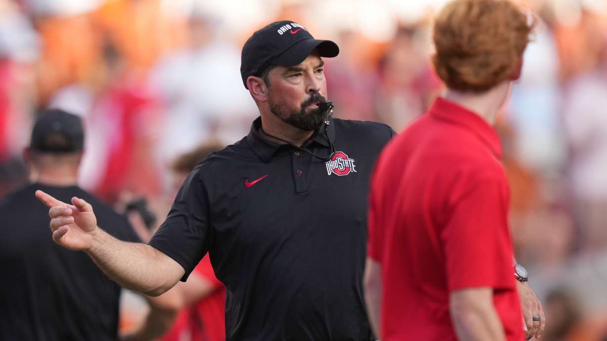 Ohio State head coach Ryan Day watches players warm up before an NCAA college football game against Texas in Austin, Texas, Saturday, Sept. 12, 2026.