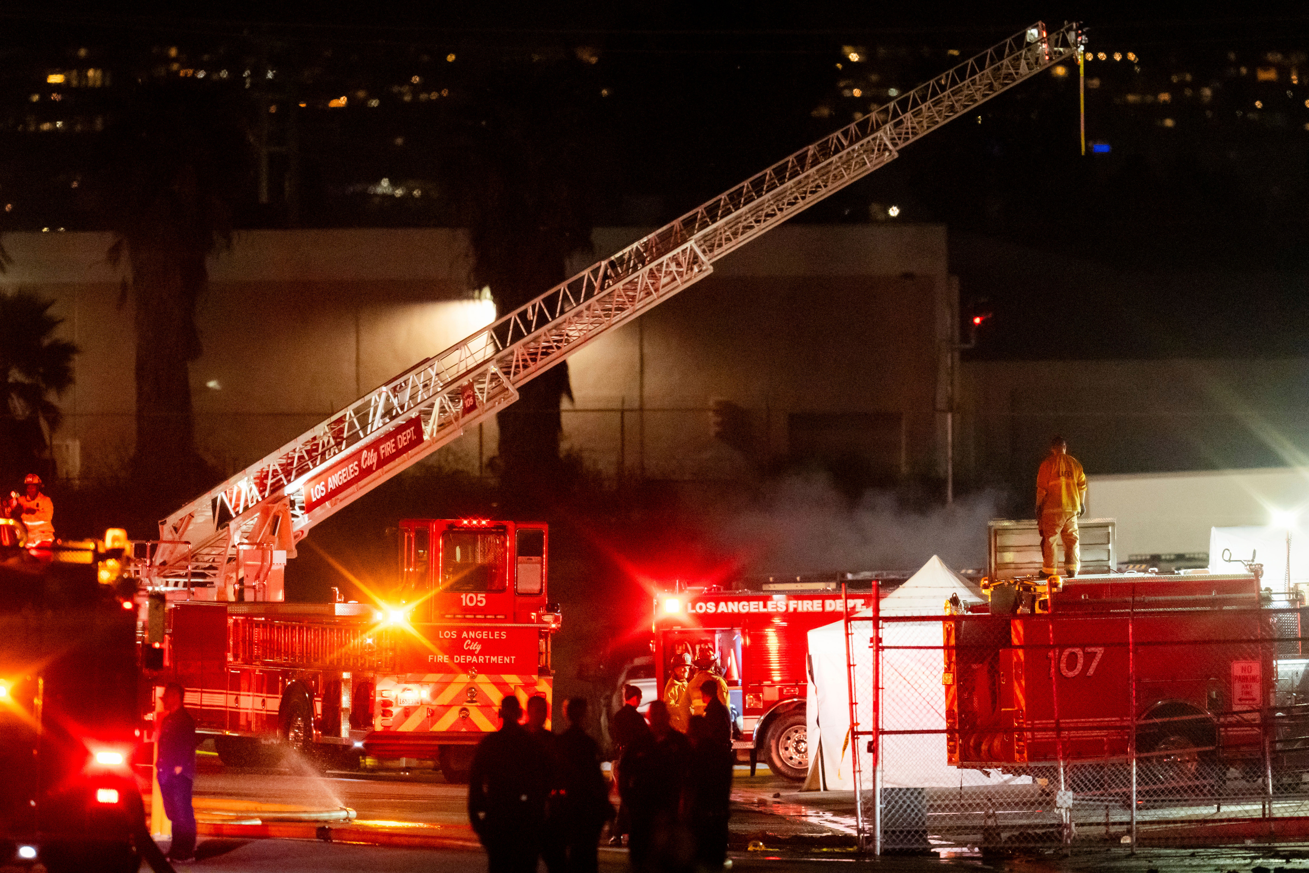 First responders work the scene after a helicopter crashed near a bus crash in Chatsworth, a neighborhood in Los Angeles, Tuesday. Officials said at least three people were killed in the crash.