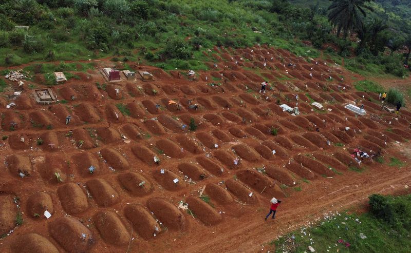 FILE PHOTO: A drone view of workers at the Ceca-20 cemetery, as aid agencies intensify efforts to contain an Ebola outbreak caused by the Bundibugyo virus, in Mungwalu, Djugu Territory of Ituri province, Democratic Republic of Congo, July 14, 2026.