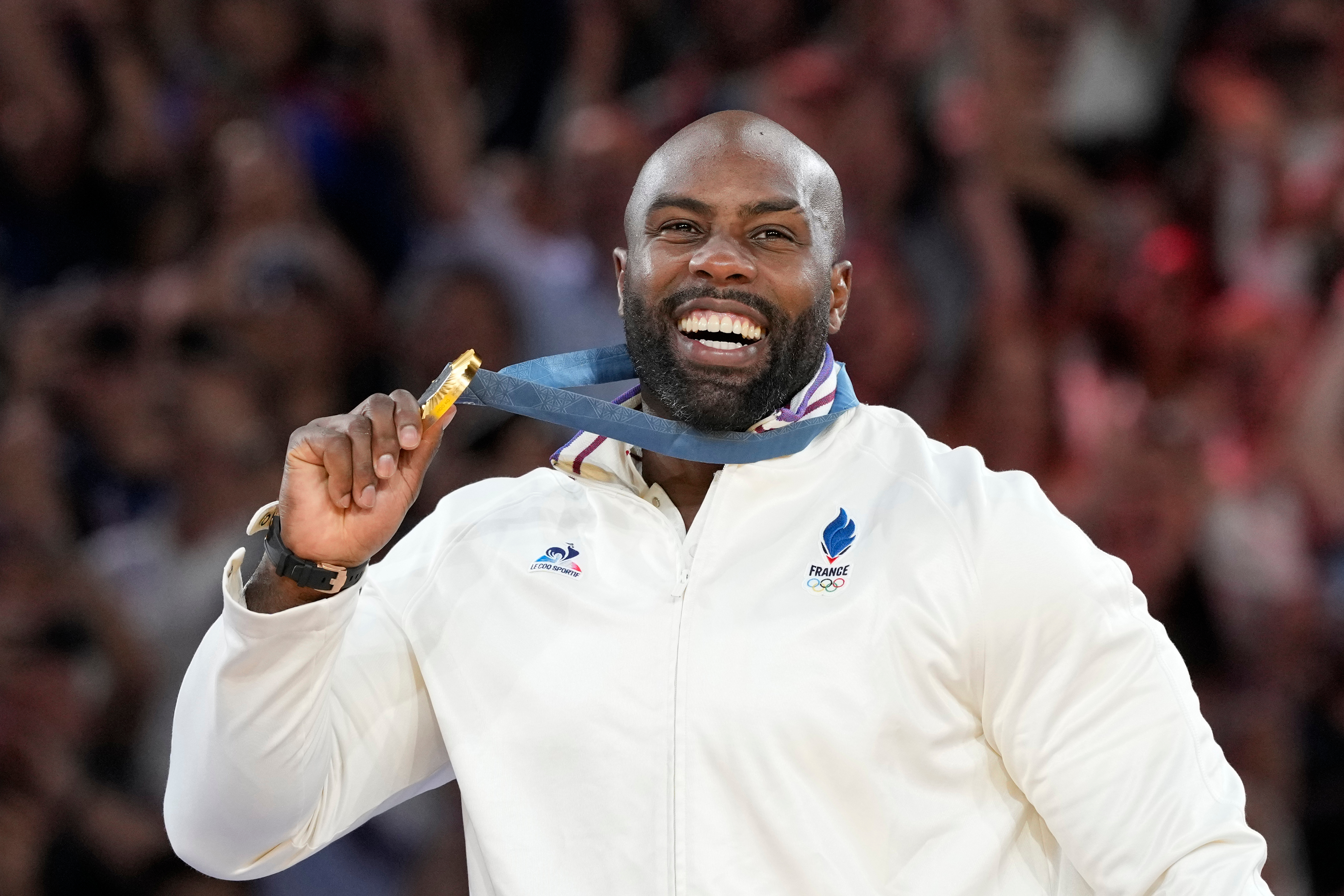 FILE - Golden medalist France's Teddy Riner poses on the podium of the judo men's +100 kg event in the team judo competition, at Champ-de-Mars Arena, during the 2024 Summer Olympics, Friday, Aug. 2, 2024, in Paris, France. 